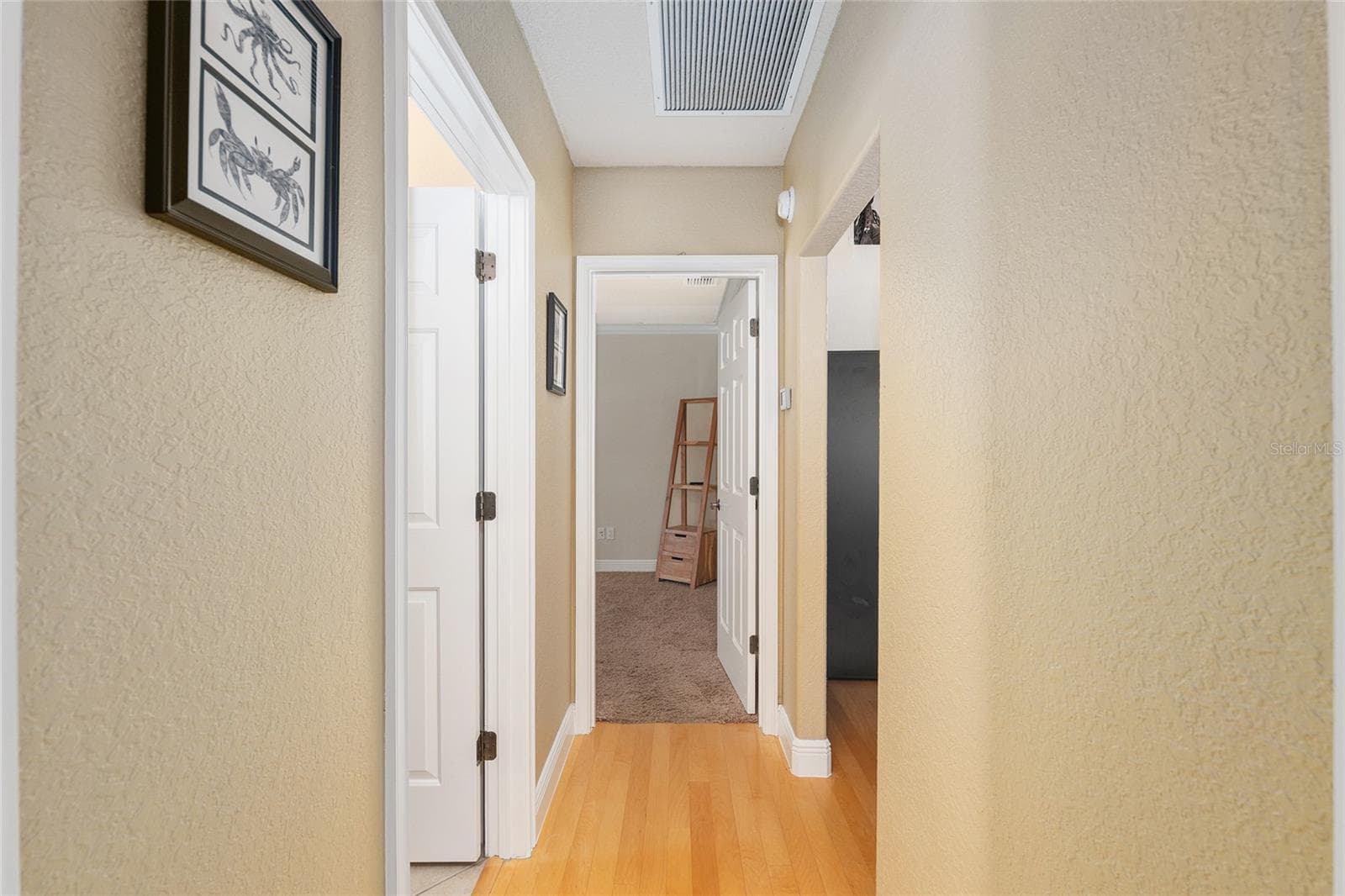 2nd bedroom view to 3rd bedroom bath on left - 29 SE OCALE WAY, SUMMERFIELD