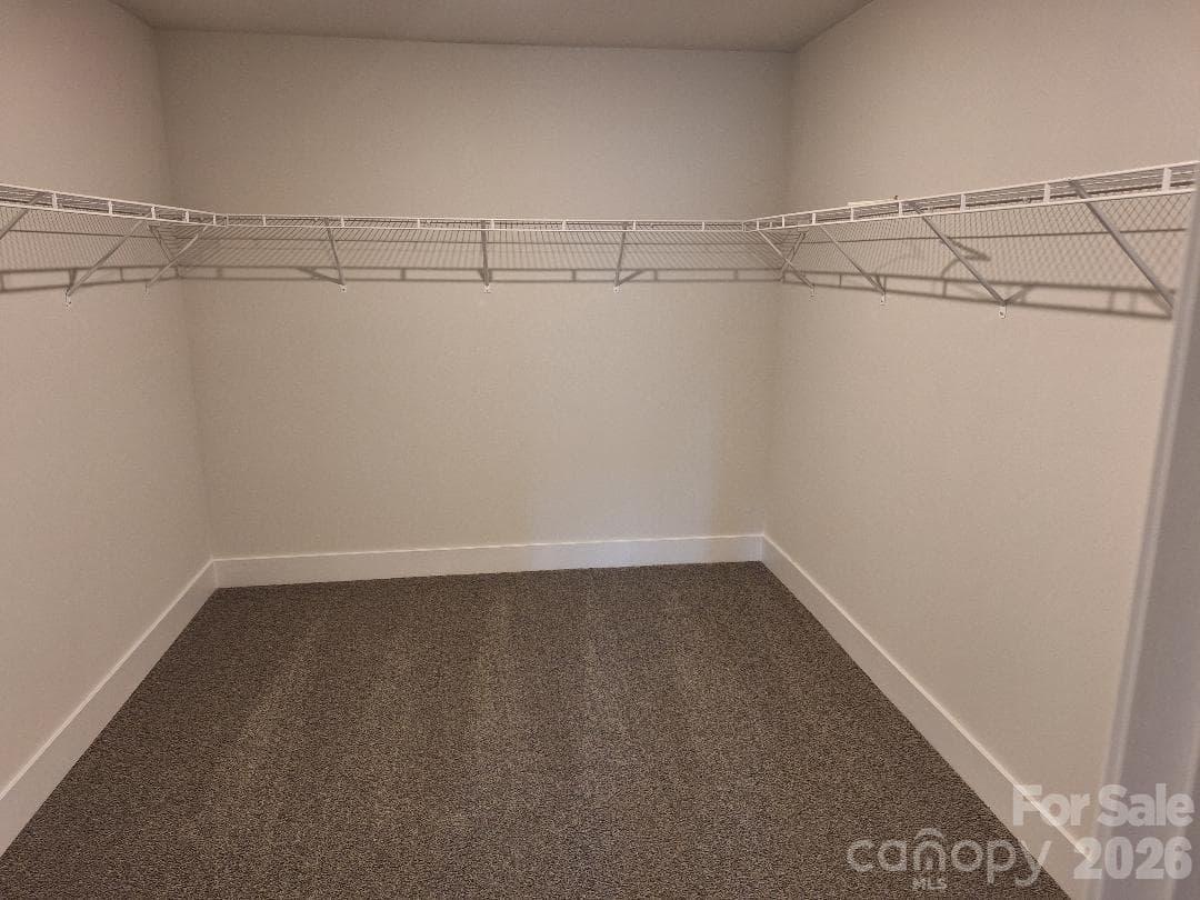 Primary Bedroom Walk-In Closet - 136 Kerr Walk Drive, Statesville