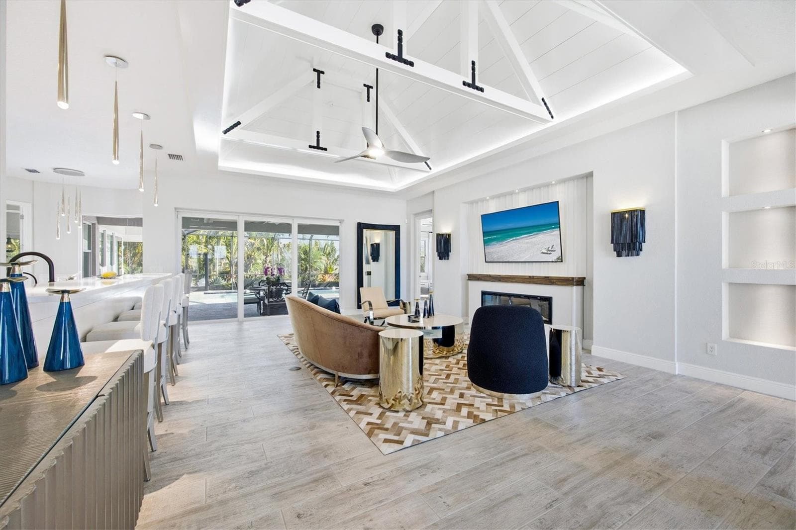 Great Room has Feature Wall with Electric Fireplace, Wood Mantle and Lighted Niches - 3467 COMPOUND CT, SARASOTA