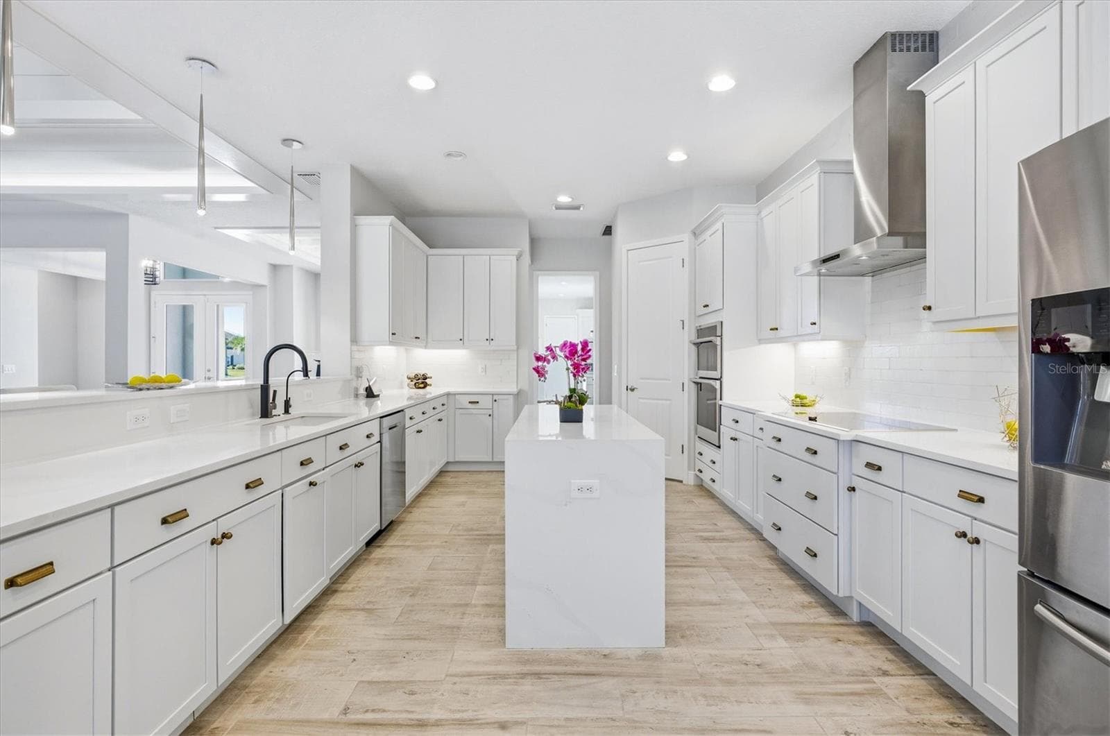 Kitchen has Shaker Style Cabinets, Quart Countertop with Waterfall Edge and Stainless Steal Appliances - 3467 COMPOUND CT, SARASOTA
