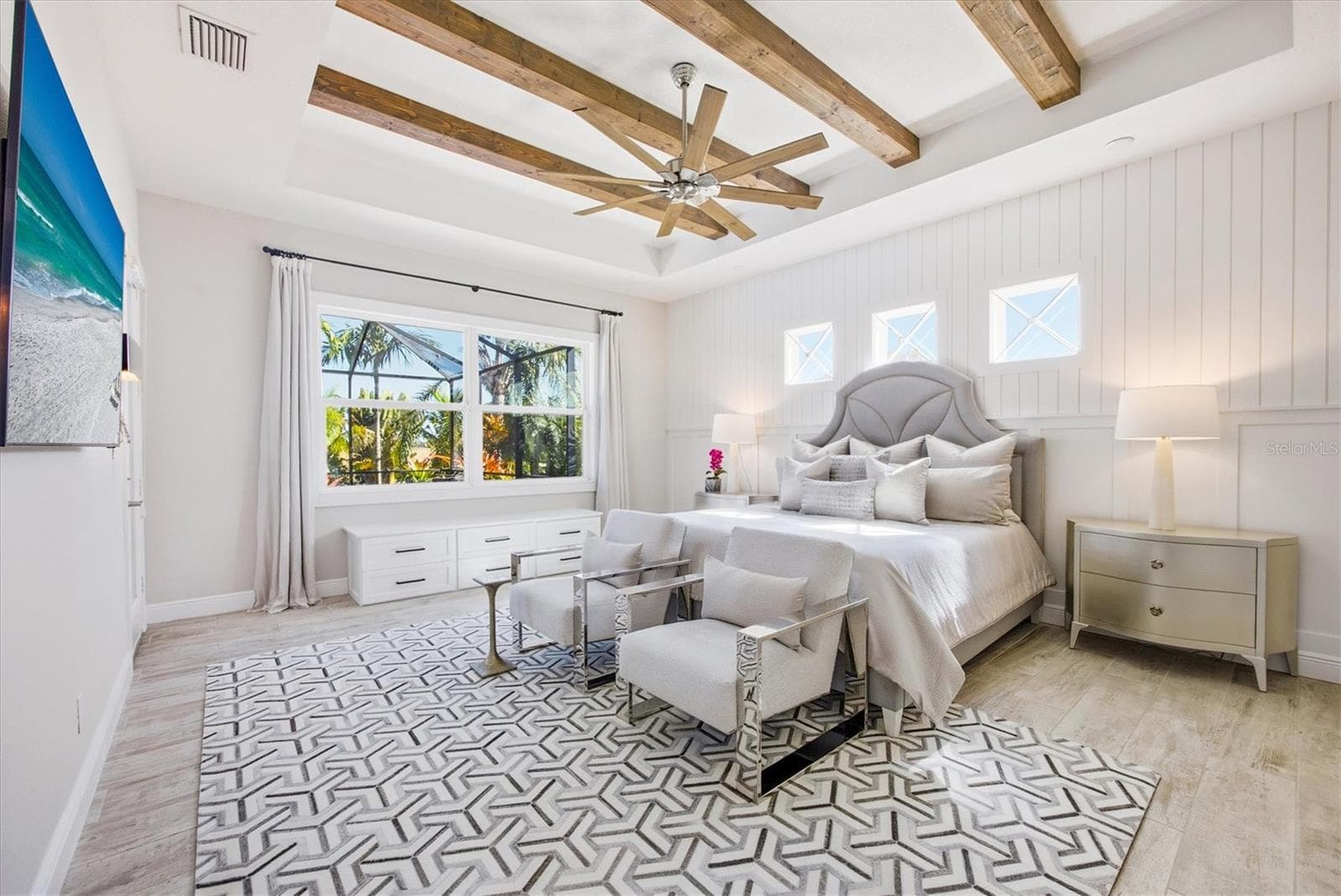 Primary Suite Bedroom has Beams, Shiplap and View of Pool with Lush Landscaping - 3467 COMPOUND CT, SARASOTA