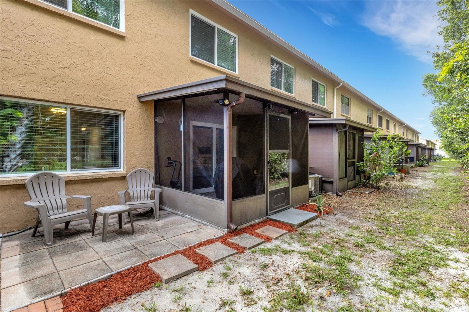 Back of Unit With Screened Porch Off Primary Bedroom and Open Sitting Area - 8039 GARDEN DR #109, SEMINOLE