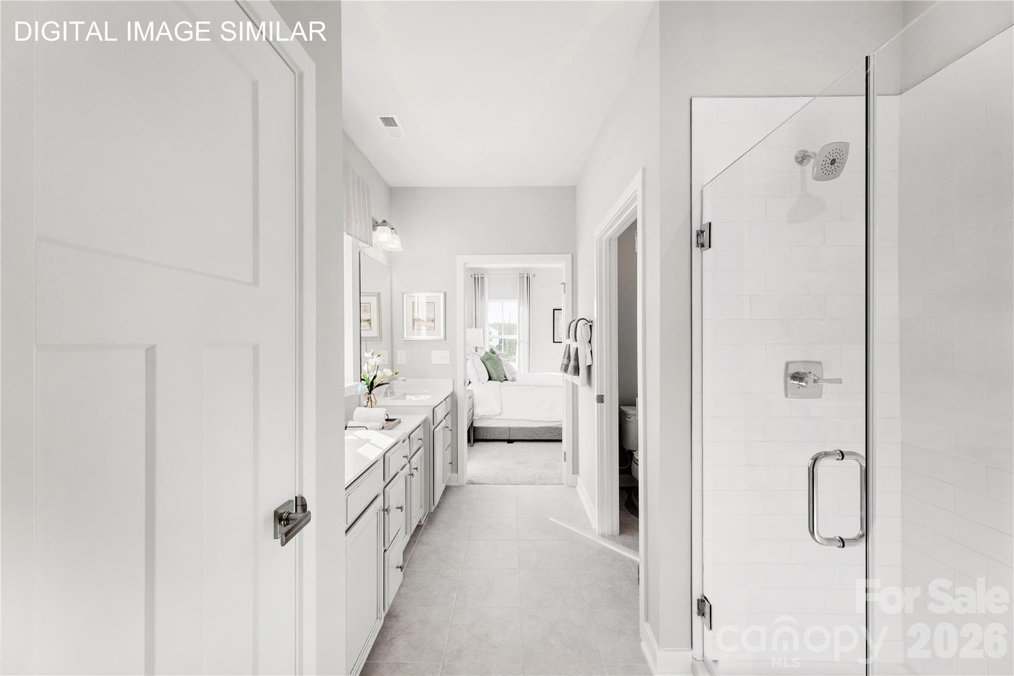 Spa-like primary bath with dual vanities, private water closet, linen storage, and walk-in shower featuring dual shower heads and built-in bench. - 11138 Emerson Landing Drive, Charlotte
