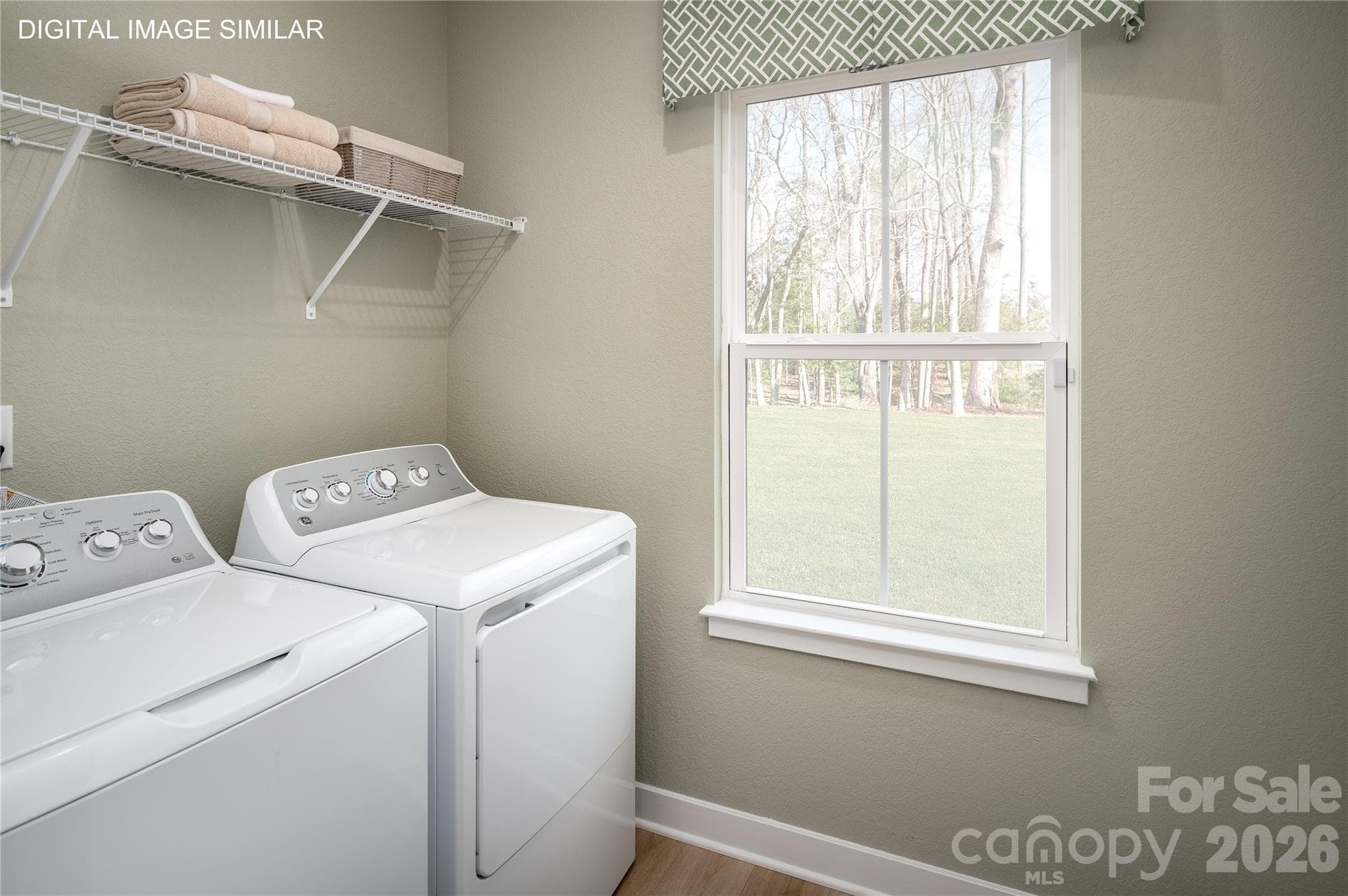First-floor laundry room with optional utility sink—conveniently located for everyday use. - 11138 Emerson Landing Drive, Charlotte