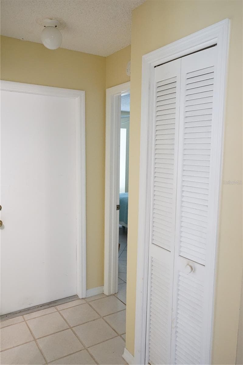 hall closet and door to guest area and garage - 652 MC DANIEL ST, SUN CITY CENTER