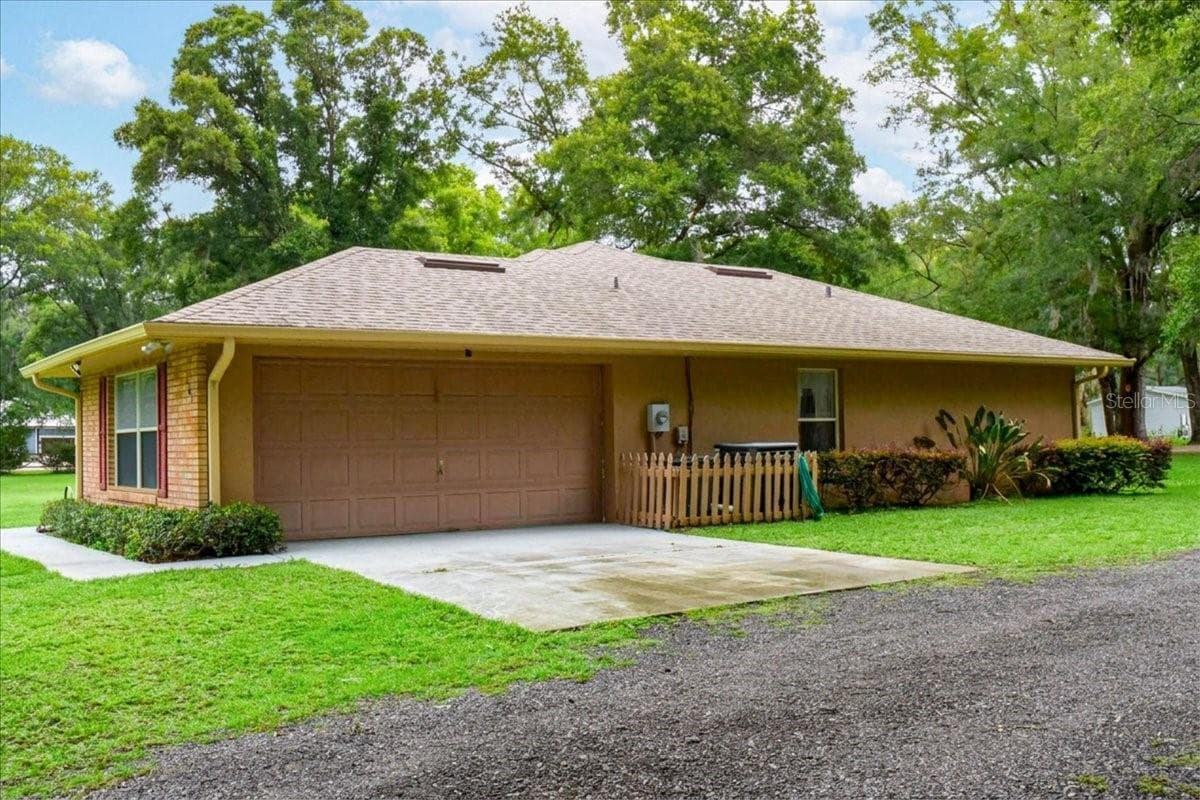 Garage elevation with ample parking and storage potential. Roof 2021 - 267 N ORANGE AVE, LAKE HELEN