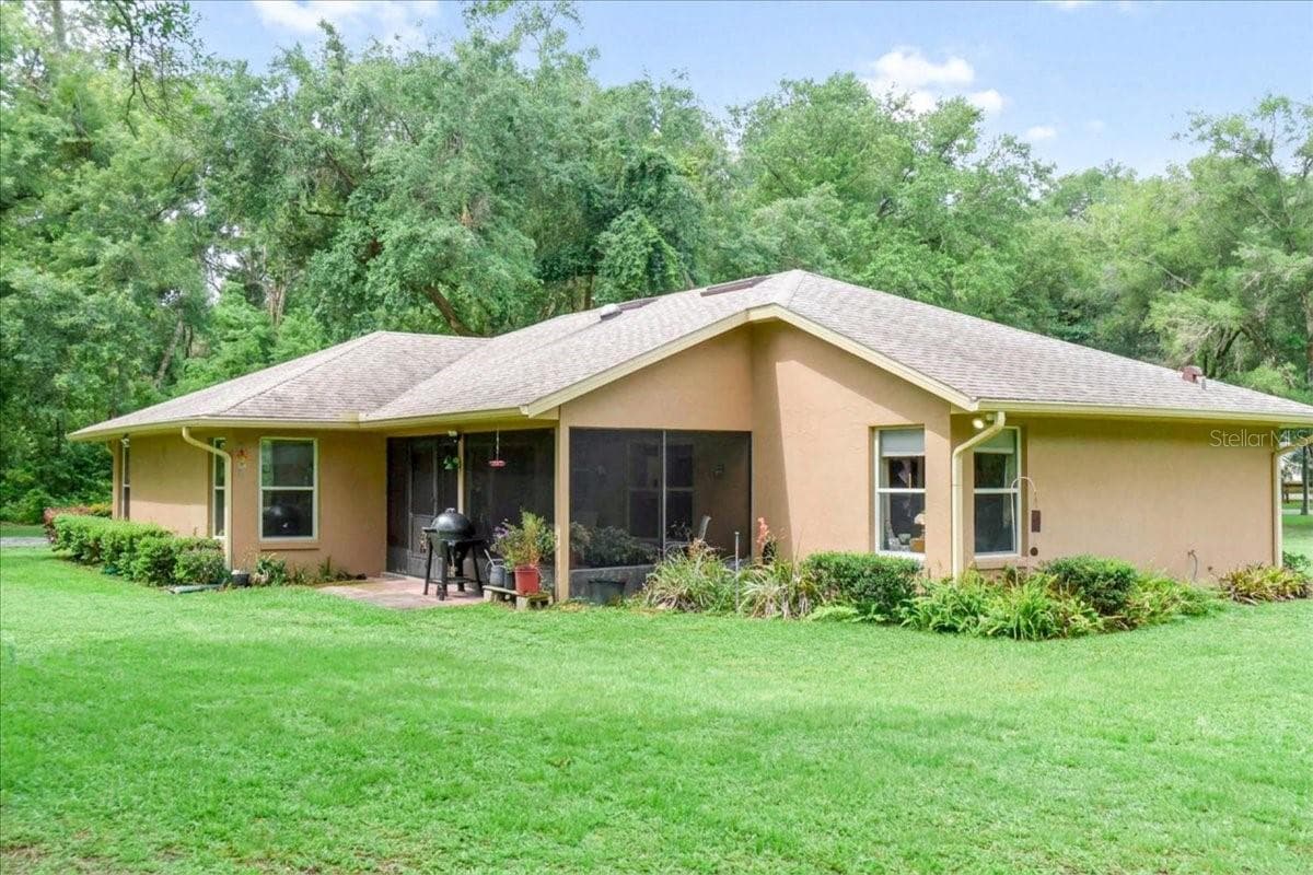 Covered rear patio overlooking the backyard and surrounding landscape. - 267 N ORANGE AVE, LAKE HELEN