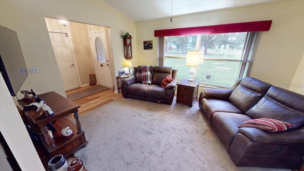 Living room featuring large front window and abundant natural light. - 267 N ORANGE AVE, LAKE HELEN