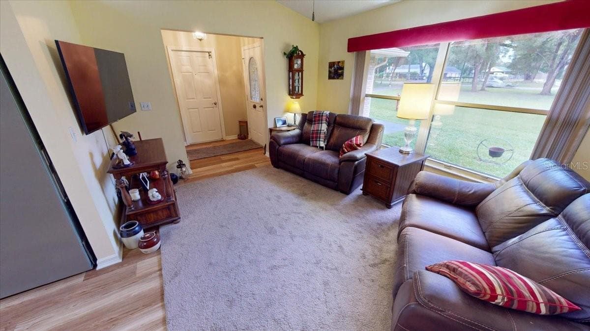 Spacious living area with open layout and opens to the dining space. - 267 N ORANGE AVE, LAKE HELEN