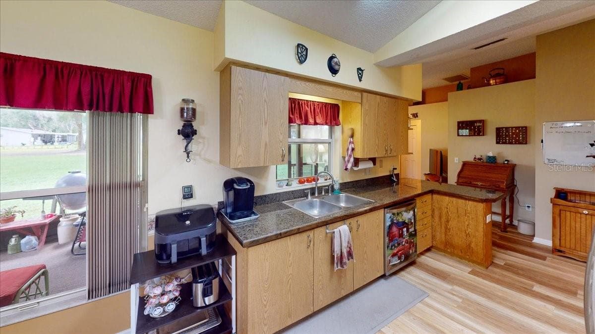 Kitchen featuring ample cabinetry, countertop workspace, and natural light. - 267 N ORANGE AVE, LAKE HELEN