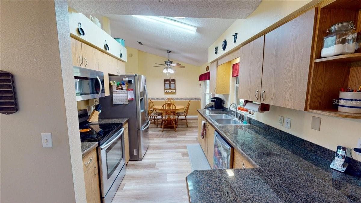 Galley-style kitchen with generous storage and functional layout. - 267 N ORANGE AVE, LAKE HELEN