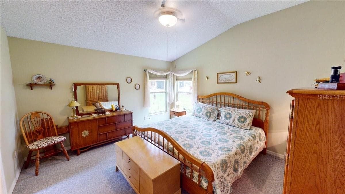 Primary bedroom featuring high ceilings, fan and generous floor space. - 267 N ORANGE AVE, LAKE HELEN