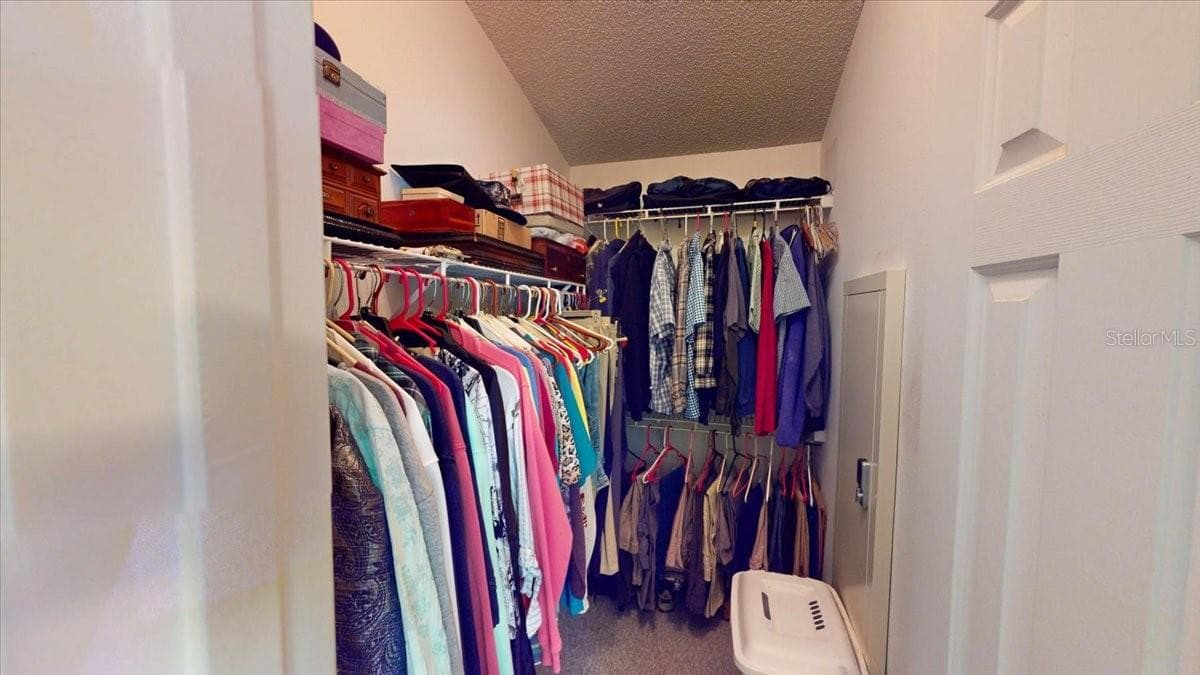 Walk-in closet with shelving and hanging storage. - 267 N ORANGE AVE, LAKE HELEN