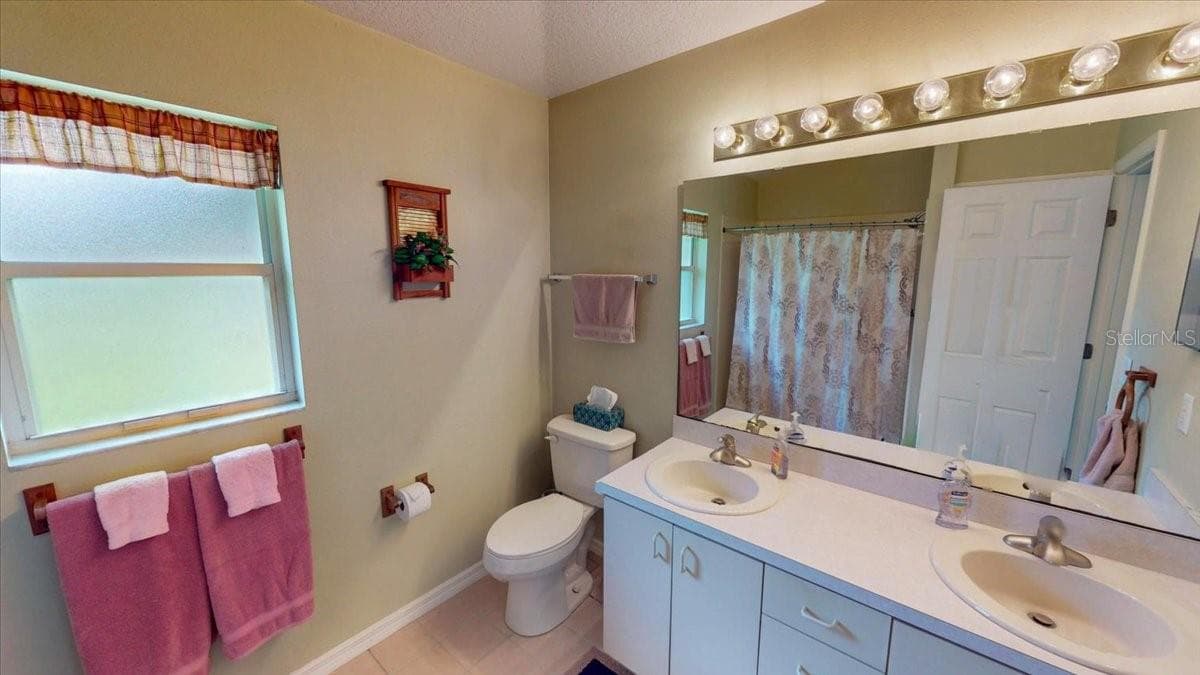 Primary bathroom very spacious with dual vanities and shower. - 267 N ORANGE AVE, LAKE HELEN