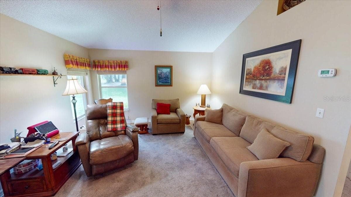 FAMILY ROOM sitting area with views of the outdoor living space. - 267 N ORANGE AVE, LAKE HELEN