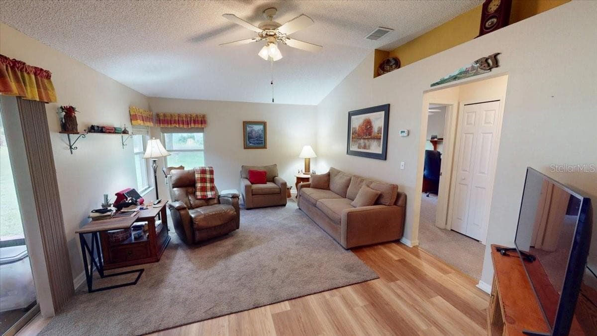 Family Room with new flooring and private access to the patio. - 267 N ORANGE AVE, LAKE HELEN