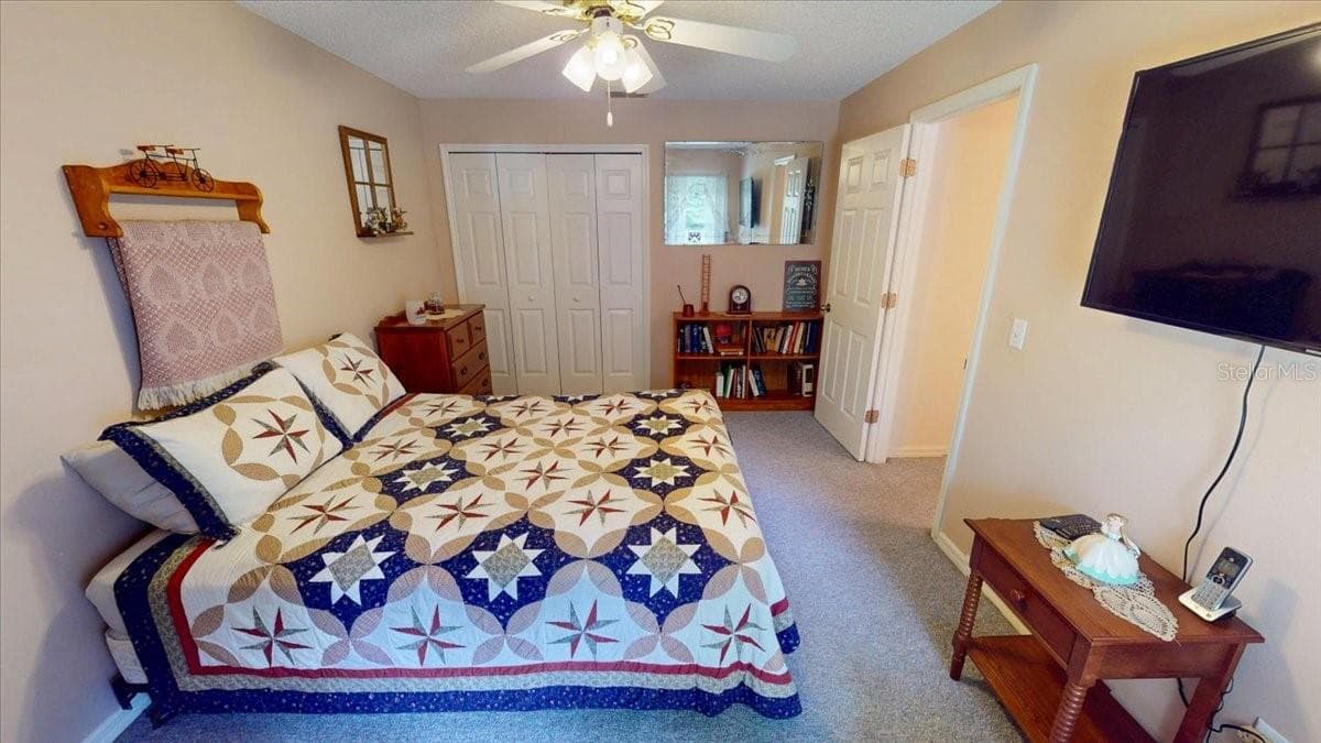 Secondary bedroom with ceiling fan and ample closet space. - 267 N ORANGE AVE, LAKE HELEN