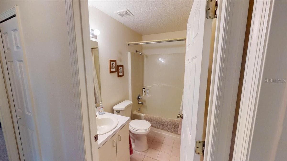 Guest bathroom featuring tub shower combo and vanity. - 267 N ORANGE AVE, LAKE HELEN