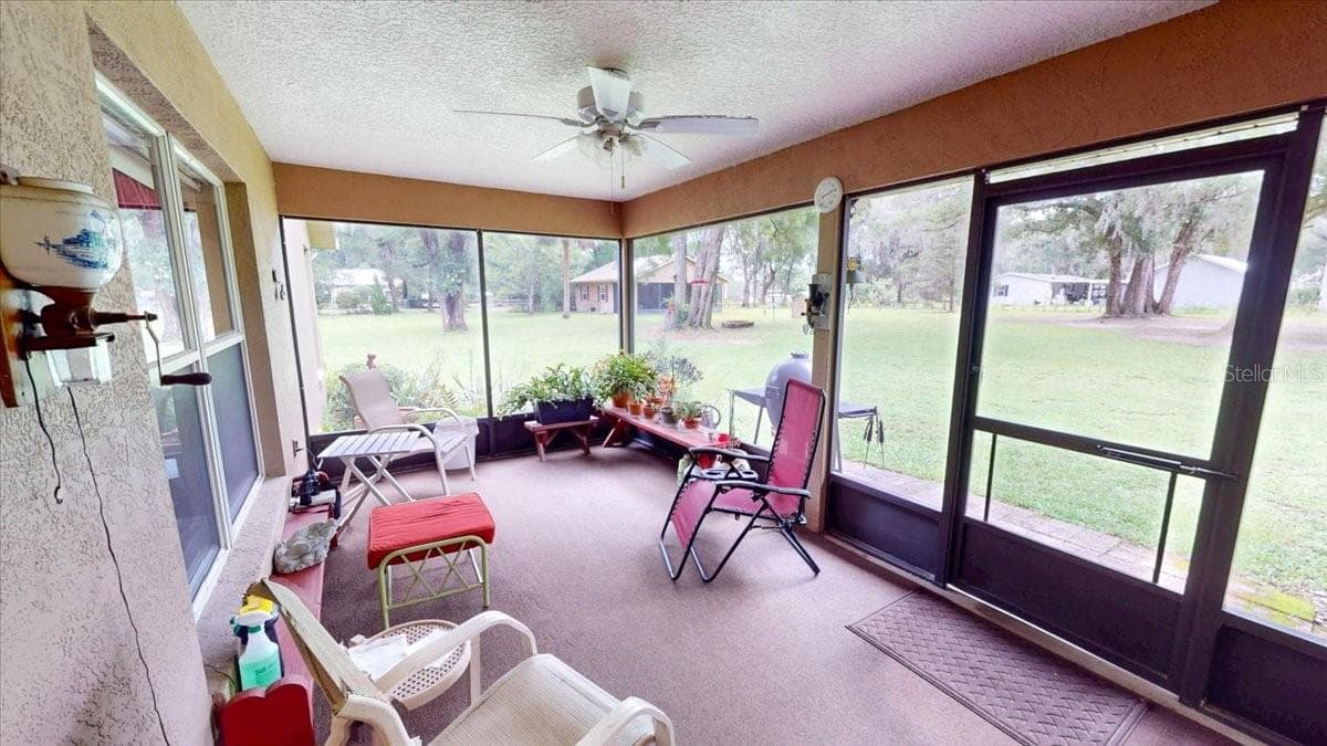 Peaceful Screened porch overlooking the backyard and surrounding landscape. - 267 N ORANGE AVE, LAKE HELEN