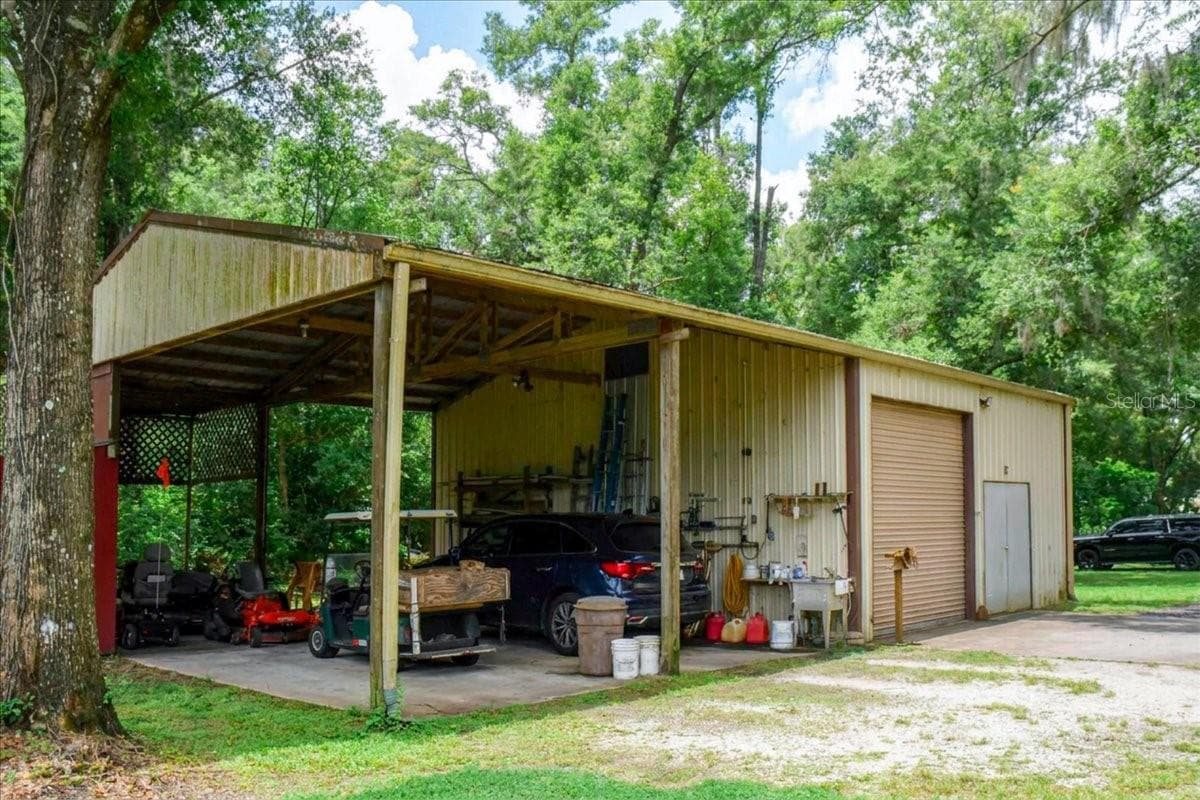 Very Tall outbuilding with 30 amp hookup -covered storage space and garage access for hobbies or equipment. - 267 N ORANGE AVE, LAKE HELEN