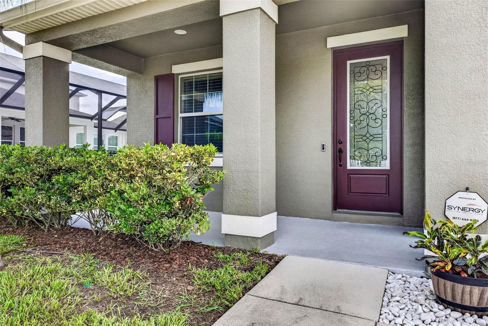Front porch with glass door and abundant light. - 7109 BAY LAUREL CT, WESLEY CHAPEL