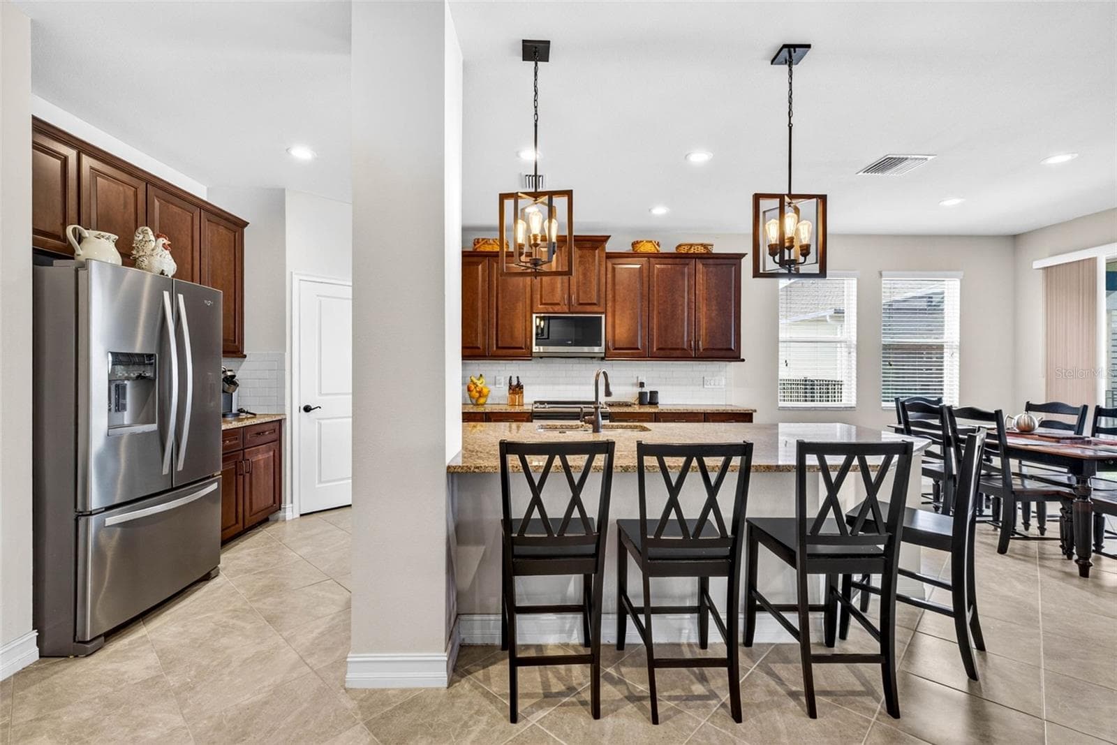 Your kitchen has classic wood cabinetry crowned & overhead light fixtures added. - 7109 BAY LAUREL CT, WESLEY CHAPEL