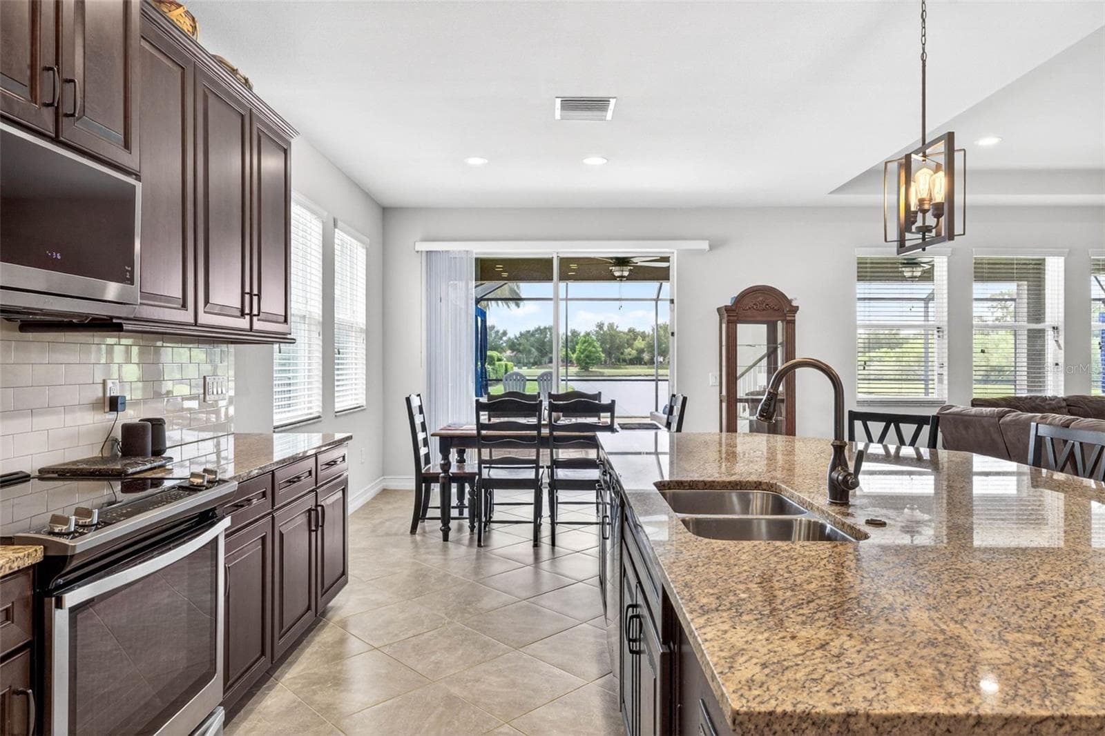 Stainless steel appliances & a view toward the dining area. - 7109 BAY LAUREL CT, WESLEY CHAPEL