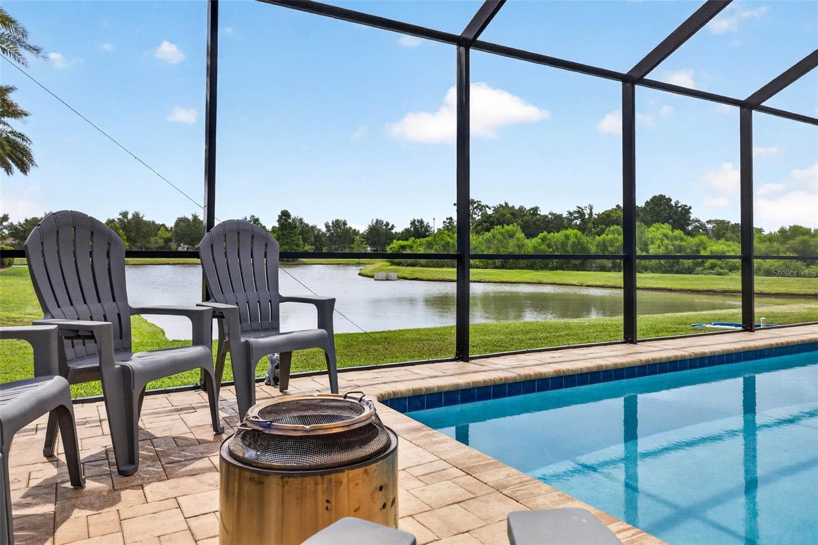 An outdoor seating area for cooler nights. - 7109 BAY LAUREL CT, WESLEY CHAPEL