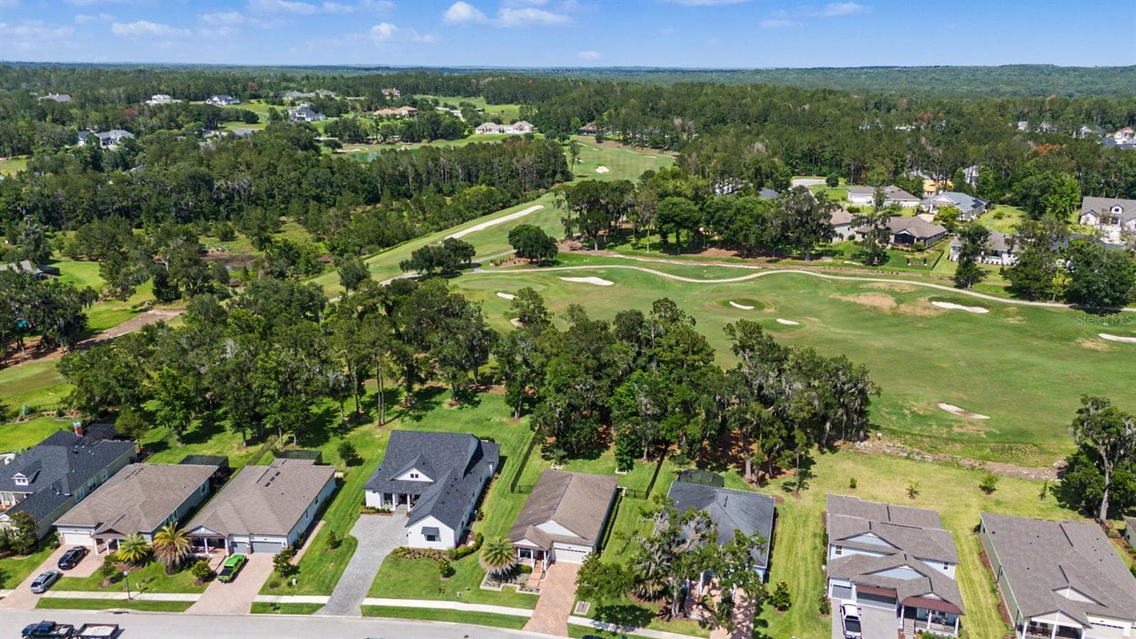 Treed backyard with golf course beyond - 4926 SOUTHERN VALLEY LOOP, BROOKSVILLE