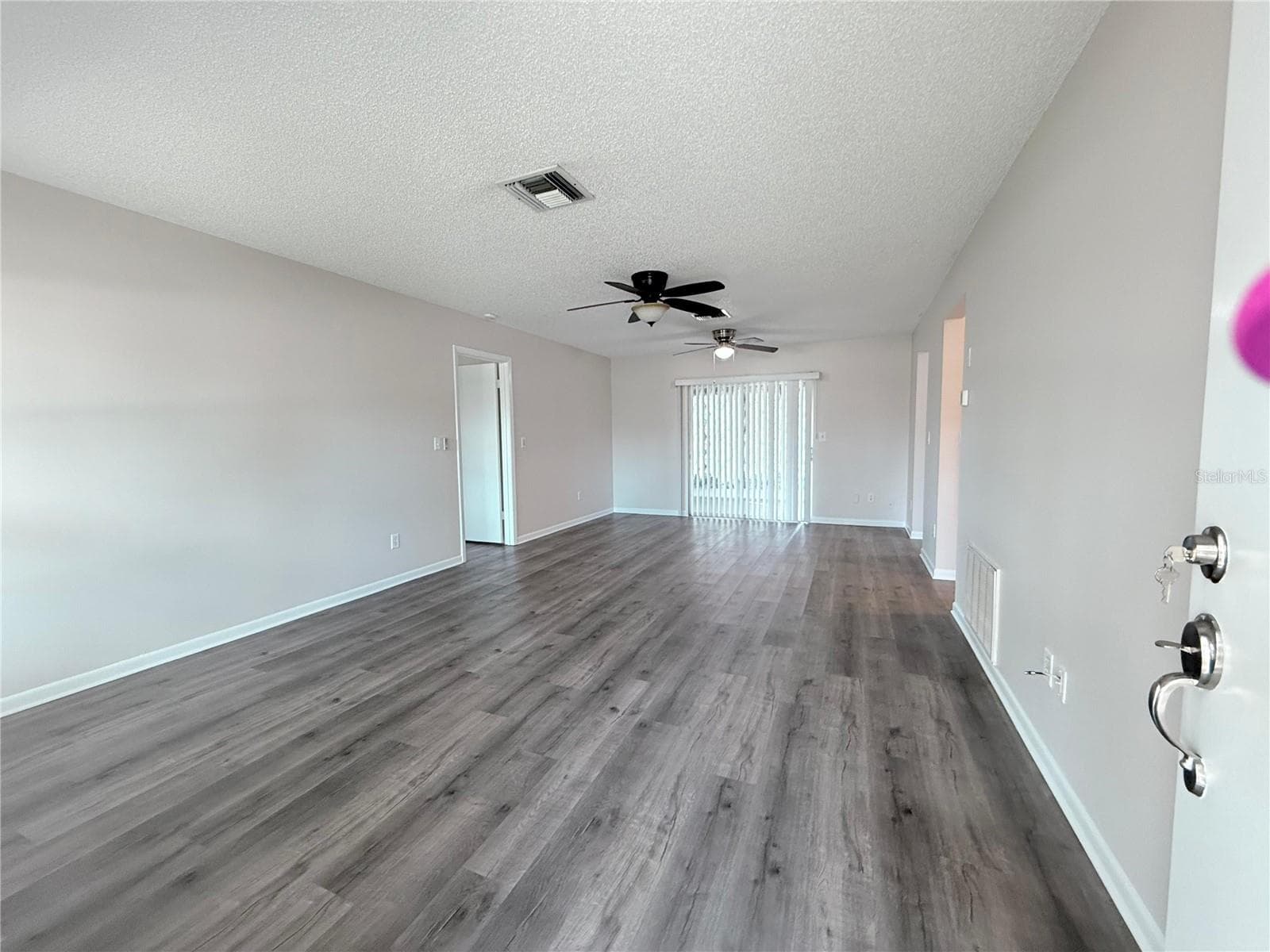 Livingroom looking from front door toward lanai - 9129 SEWELL LN, SPRING HILL