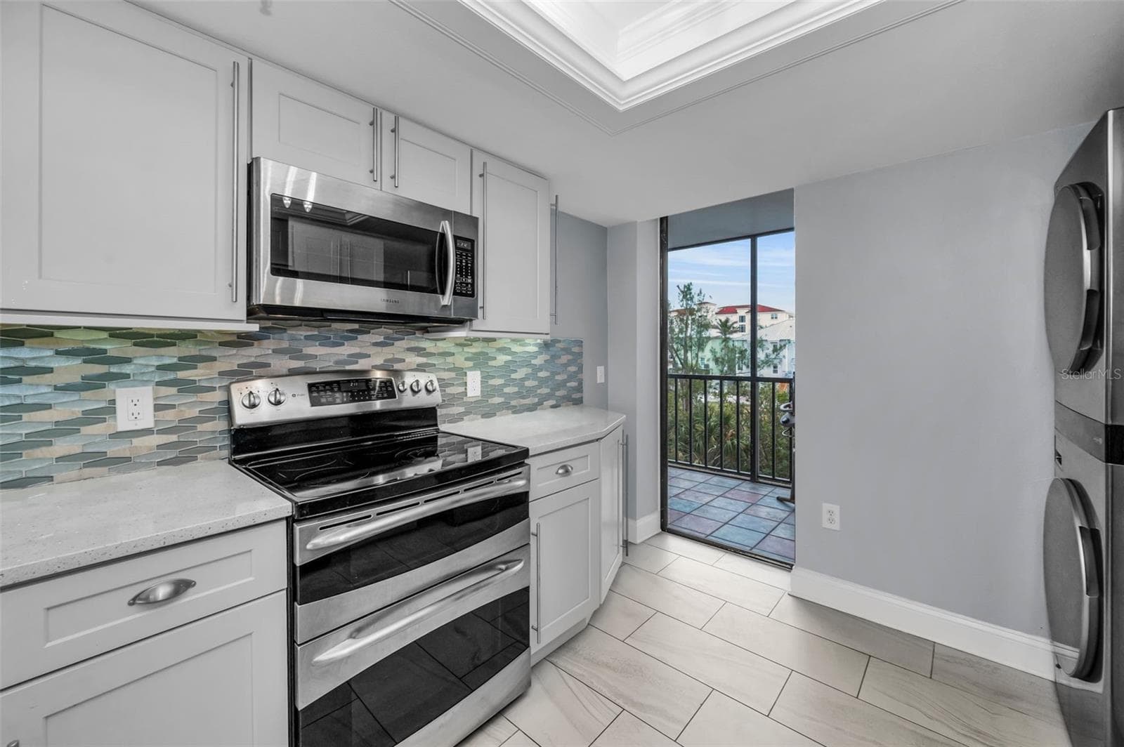 Other view showing the inside washer & dryer and slider to the west facing balcony - 19111 VISTA BAY DR #304, INDIAN SHORES