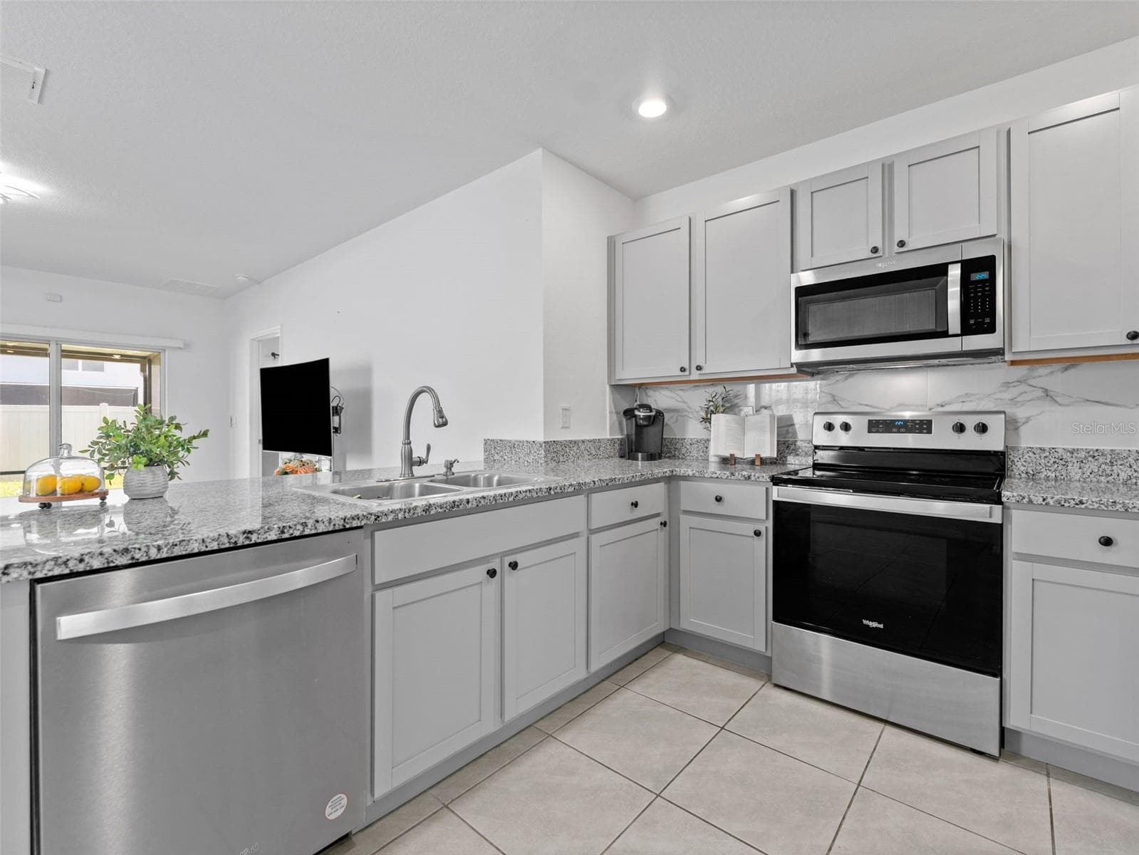 Well appointed kitchen opens to living room. - 5782 HOLLINGWORTH TRL, WESLEY CHAPEL