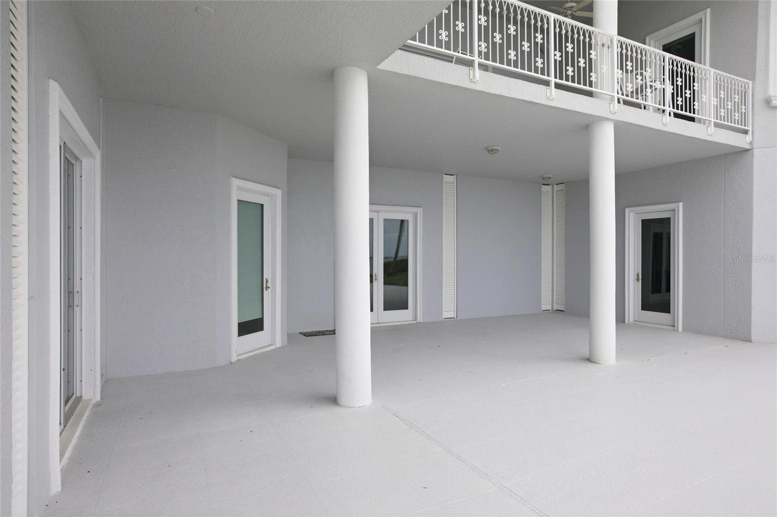 The pool deck continues under the 2nd floor entertainment deck - 7524 WESTMORELAND DR, SARASOTA