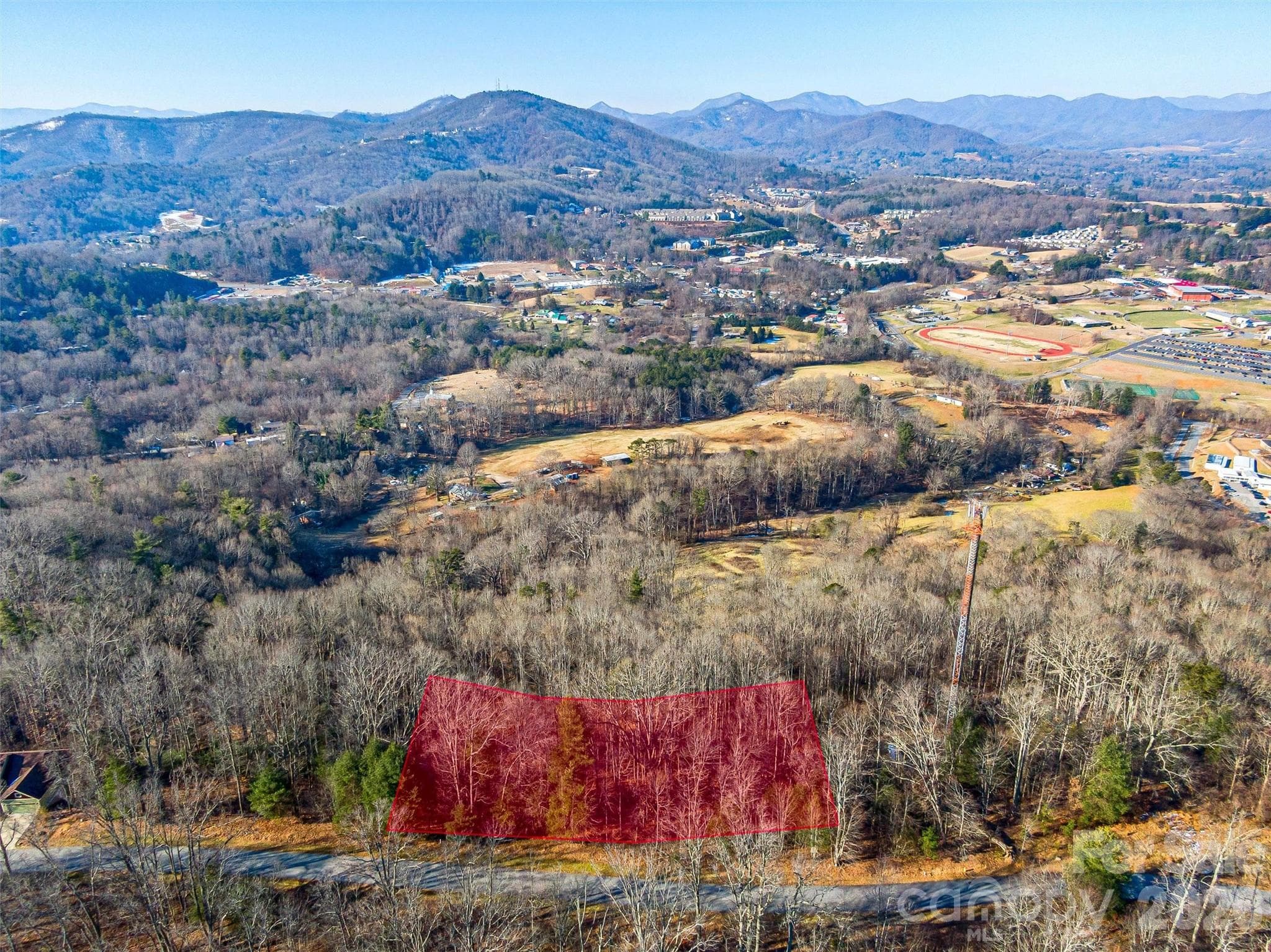 Priced aggressively at just $60,000, this gently sloping homesite presents a rare opportunity to build in one of Asheville’s premier gated mountain communities without the premium price tag. - Asheville