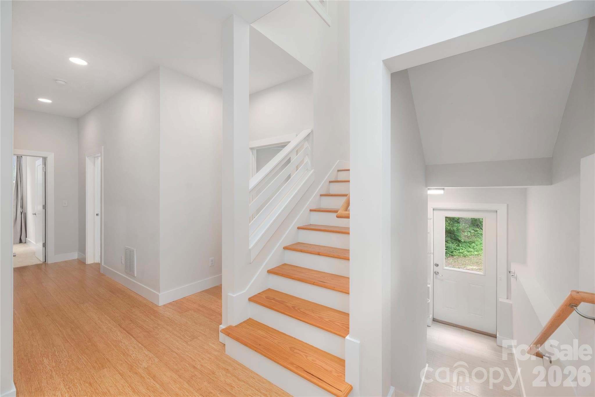 Large and light-filled stairs going down to finished lower level. - 39 Hubbard Avenue, Asheville