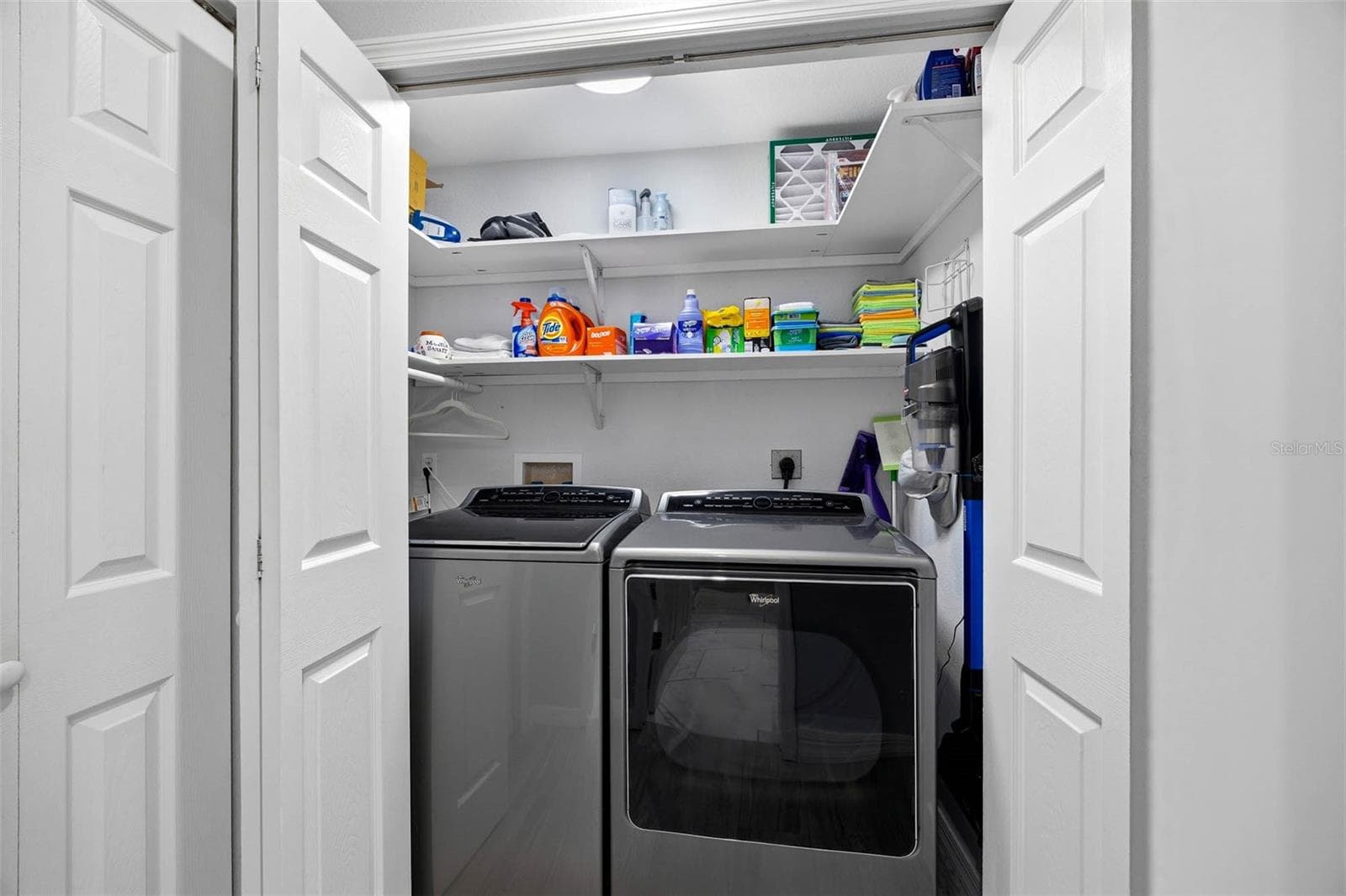 Laundry Closet with full size washer and dryer on main living level. - 2395 HANOVER DR, DUNEDIN