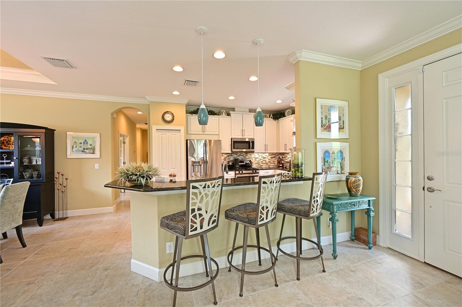 Modern kitchen with white cabinets and solid surface counters - 5007 SERATA DR, BRADENTON