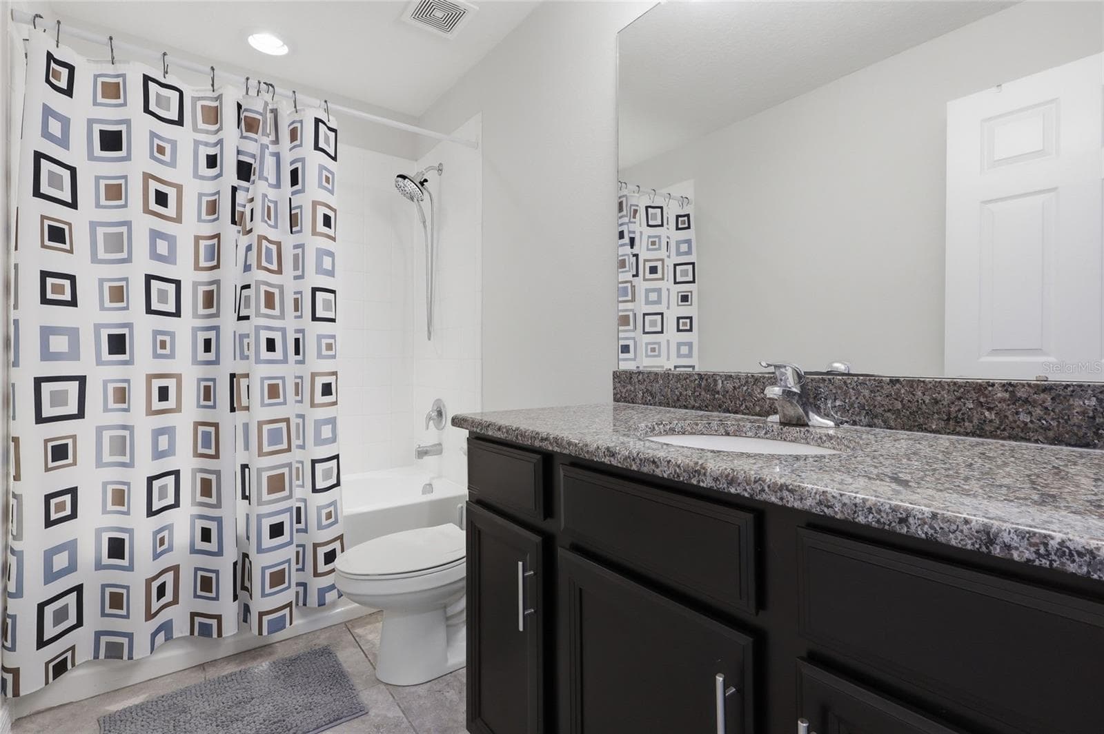 Full bathroom featuring a tub shower combo and granite topped vanity - 7005 GRAND ELM DR, RIVERVIEW