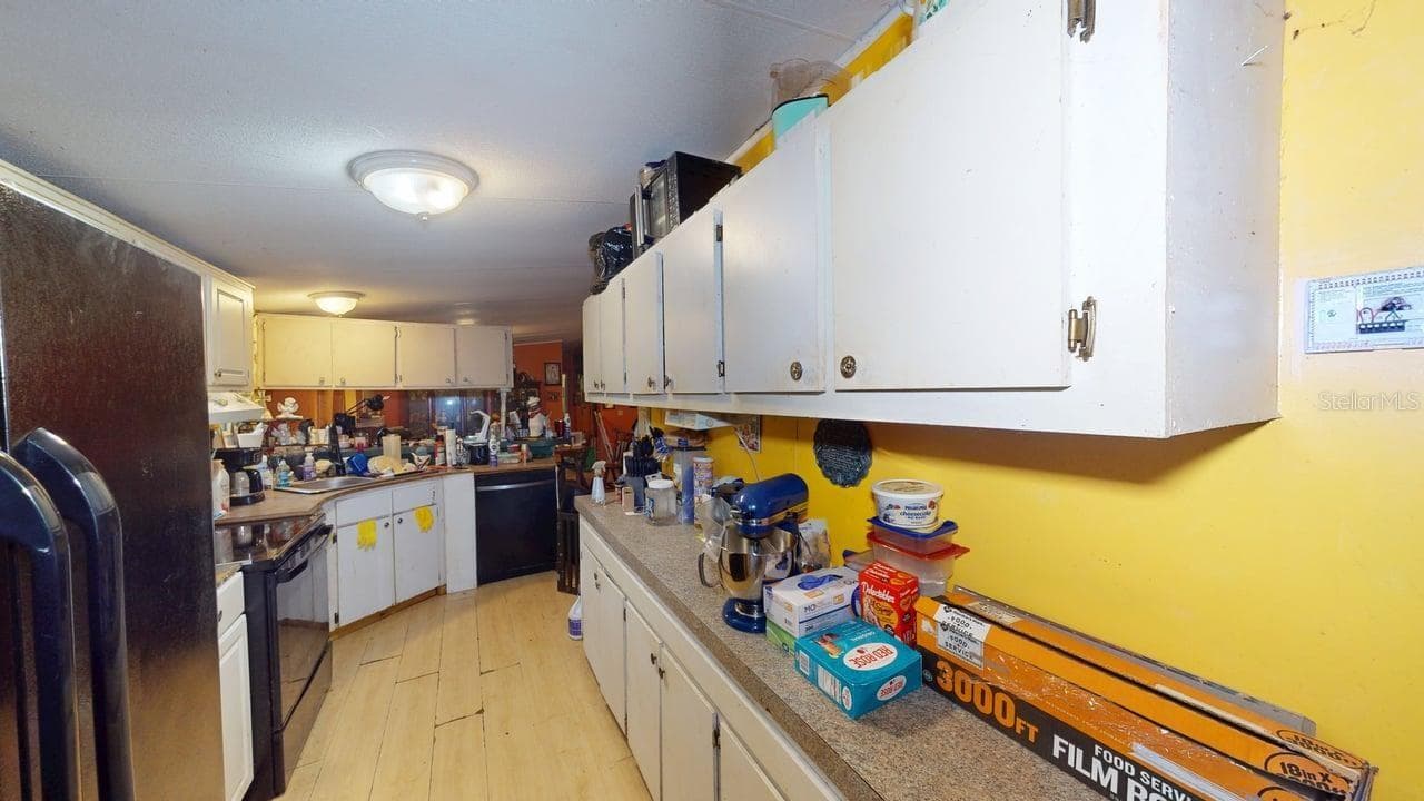 Kitchen view from the eat in space & laundry - 30501 CLEARVIEW DR, WESLEY CHAPEL