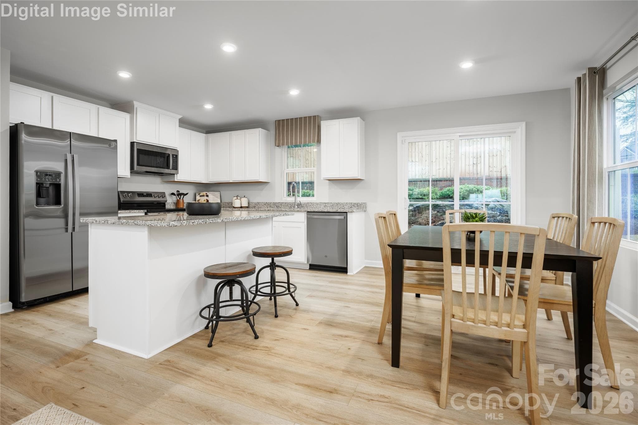 Entertain in Style! Enjoy the spacious kitchen island & adjacent dining area—perfect for hosting friends, family dinners & everyday moments! - Hickory