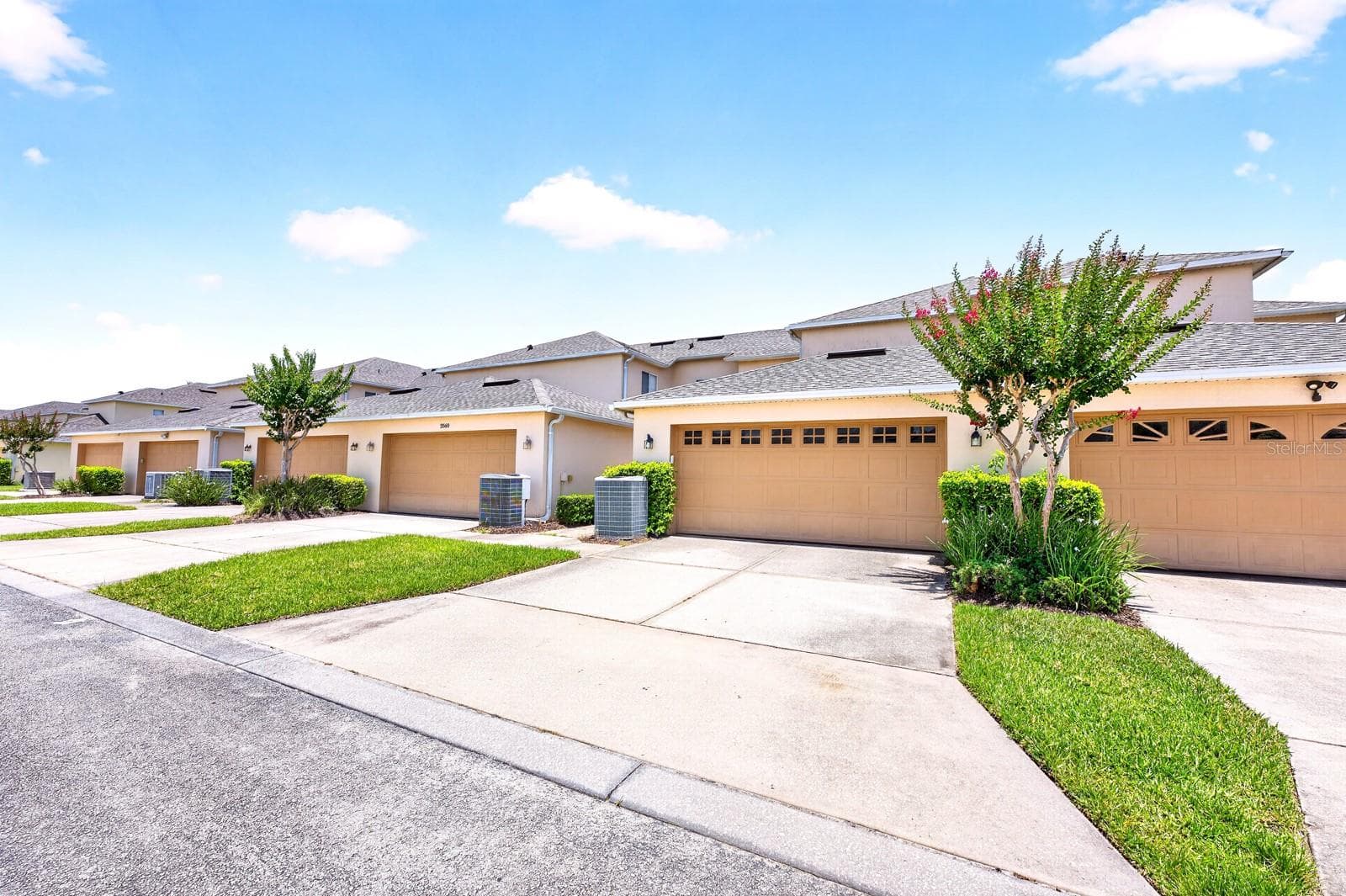Outside, a rear-entry TWO-CAR GARAGE offers ample parking and storage. - 2564 ABEY BLANCO DR, ORLANDO