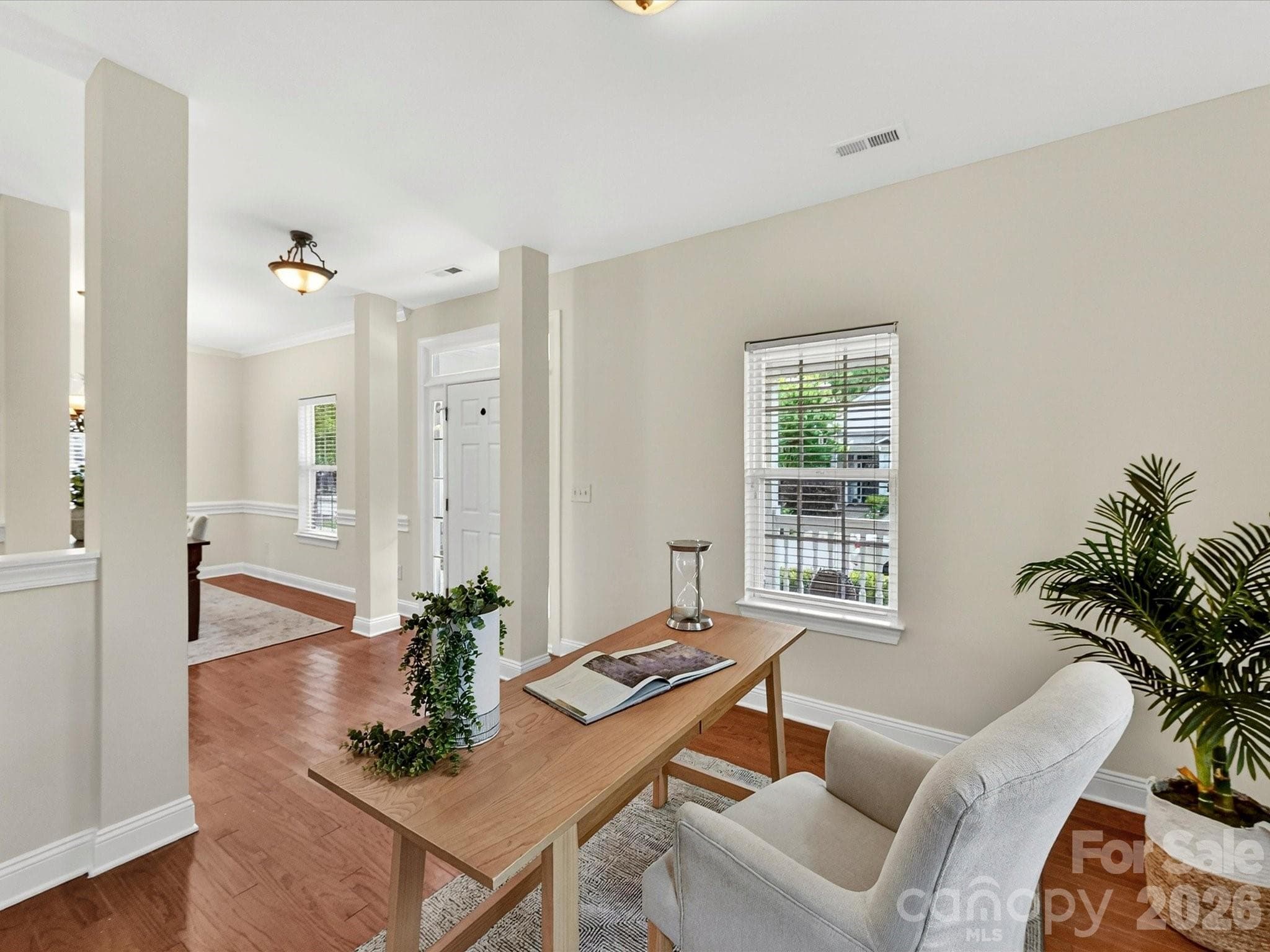 Versatile office or flex space features wood flooring, abundant natural light, and ample room for a home office, study, playroom, or additional living area. - Cornelius