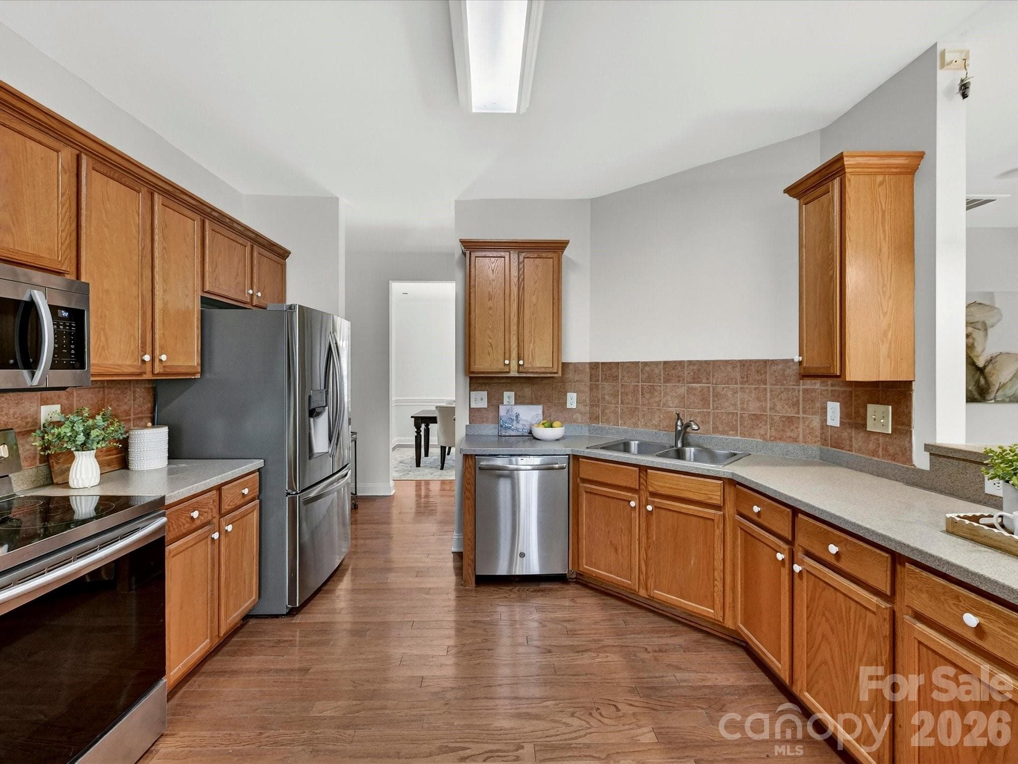 Spacious kitchen offers abundant cabinetry, expansive hard surface counters, stainless steel appliances, pantry and a seamless connection to the breakfast area and main living spaces. - Cornelius