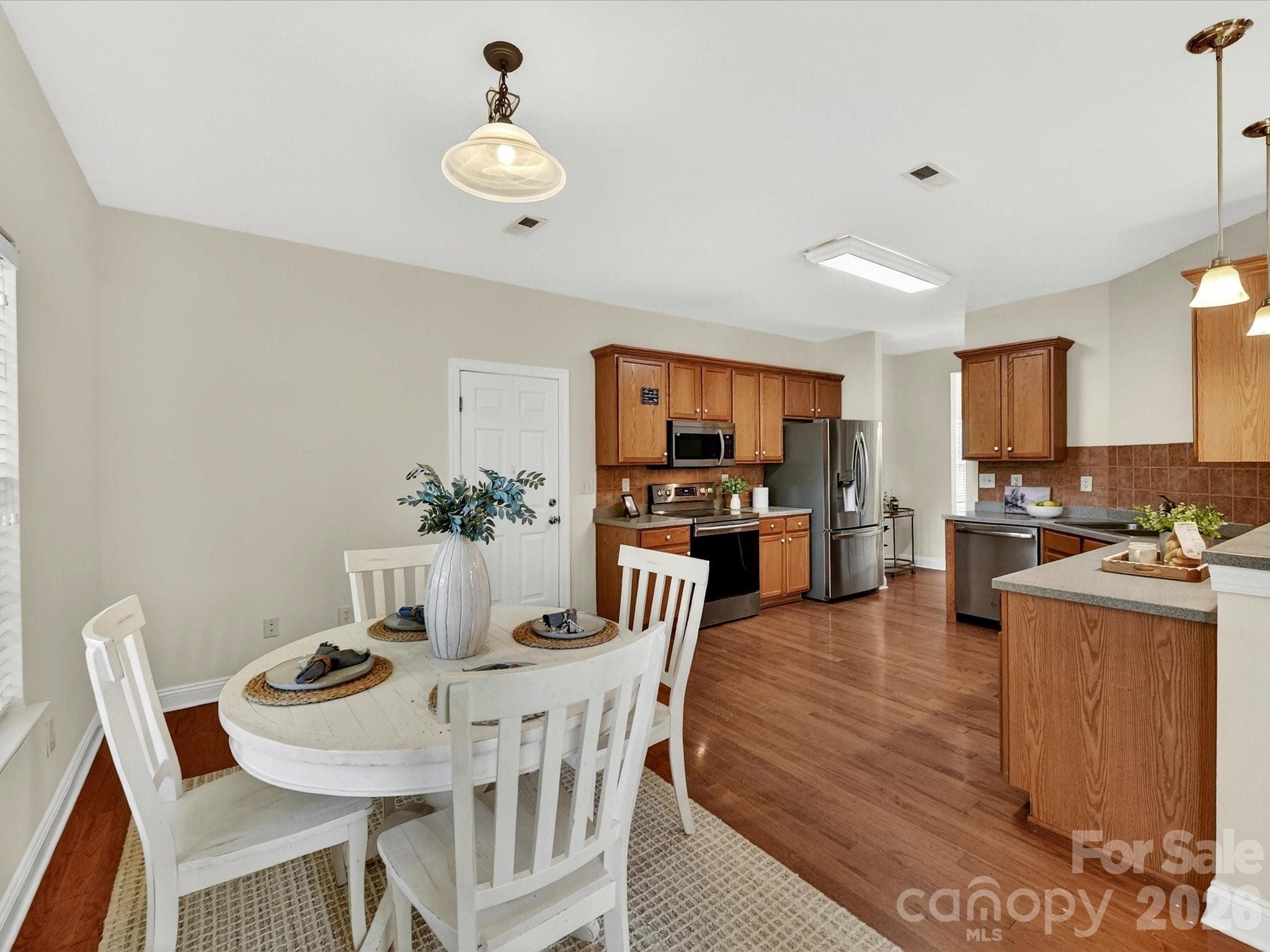 Sunny breakfast nook overlooks the backyard and flows effortlessly into the well-appointed kitchen, creating an inviting space for casual dining and everyday gathering. - Cornelius