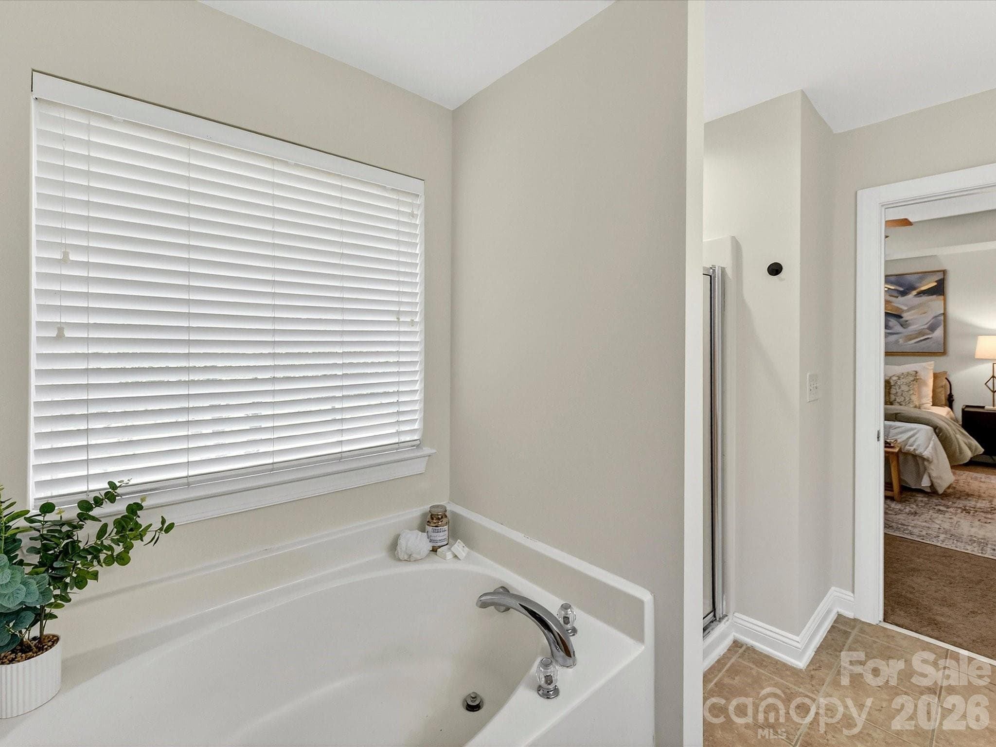 Primary bathroom features a dual-sink vanity, relaxing garden tub, separate shower, and generous space designed for comfort and everyday convenience. - Cornelius