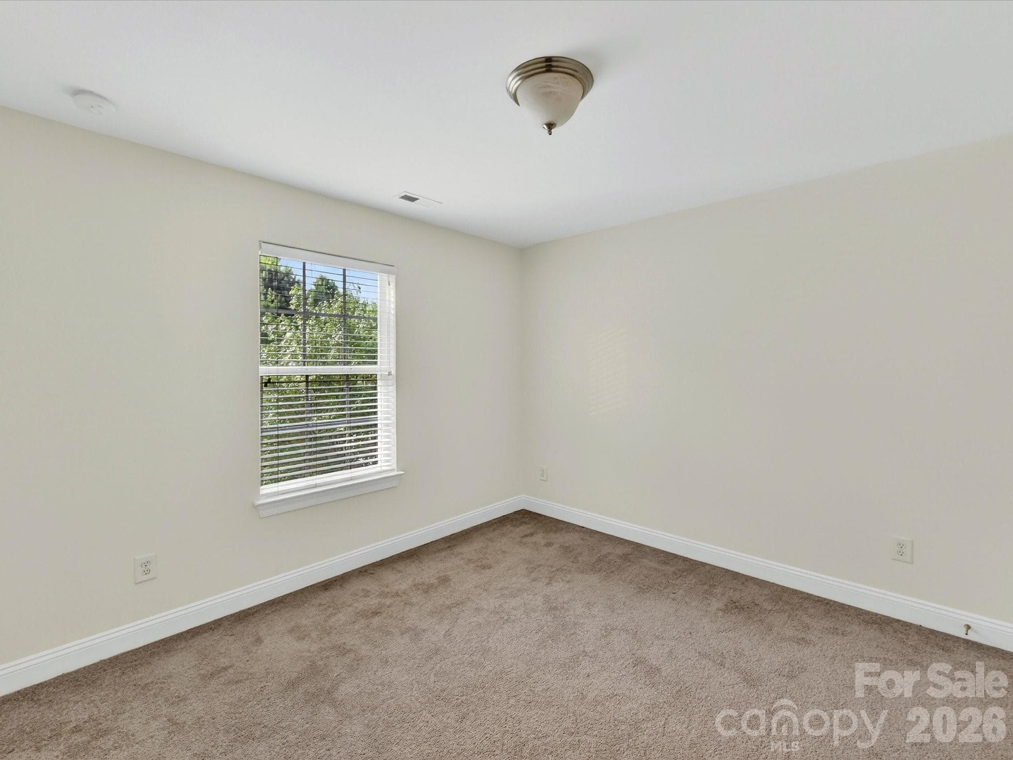Spacious secondary bedroom offers comfortable accommodations with ample closet space, soft natural light, and a versatile layout to suit a variety of needs. - Cornelius