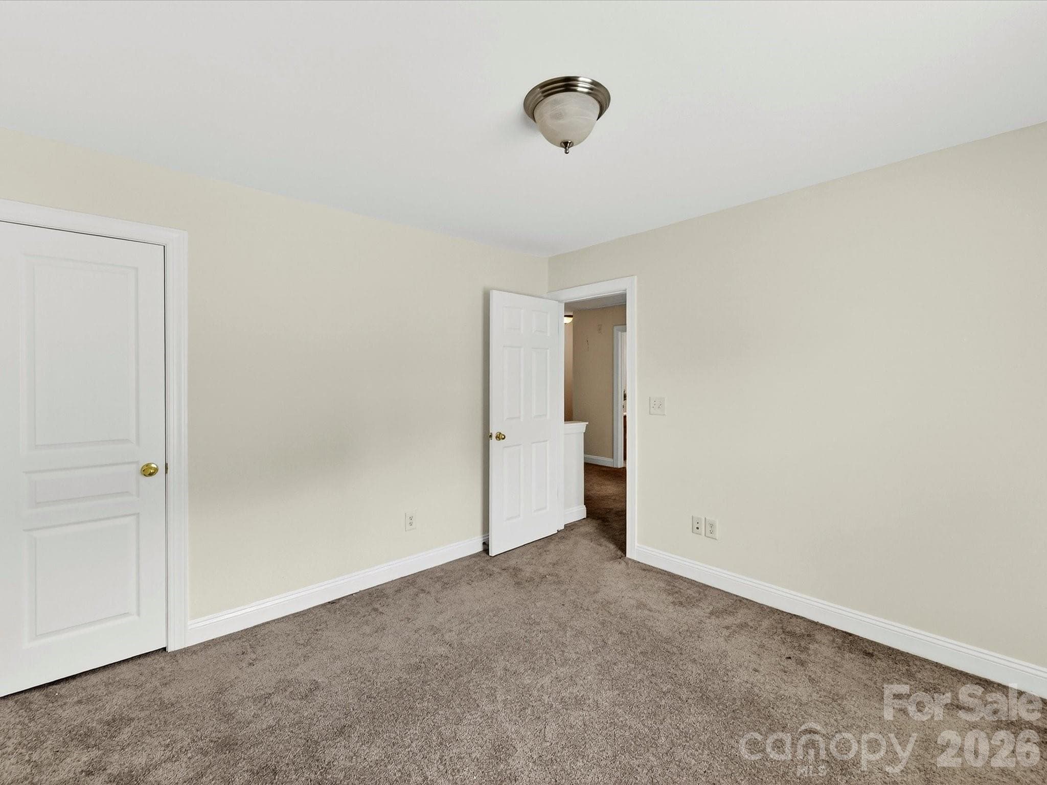 Spacious secondary bedroom offers comfortable accommodations with ample closet space, soft natural light, and a versatile layout to suit a variety of needs. - Cornelius