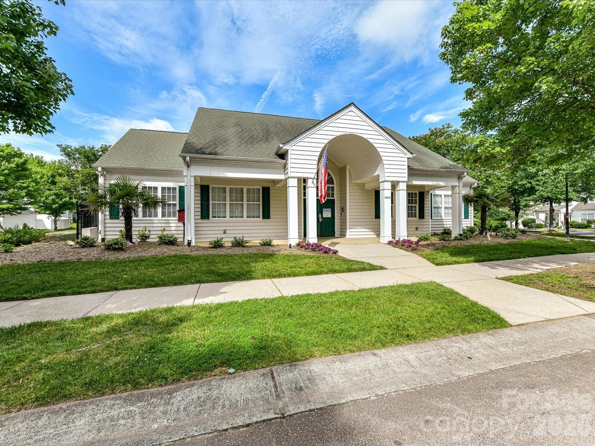 The neighborhood clubhouse provides an inviting gathering space for residents, featuring attractive architecture and well-maintained surroundings for community events and social activities. - Cornelius