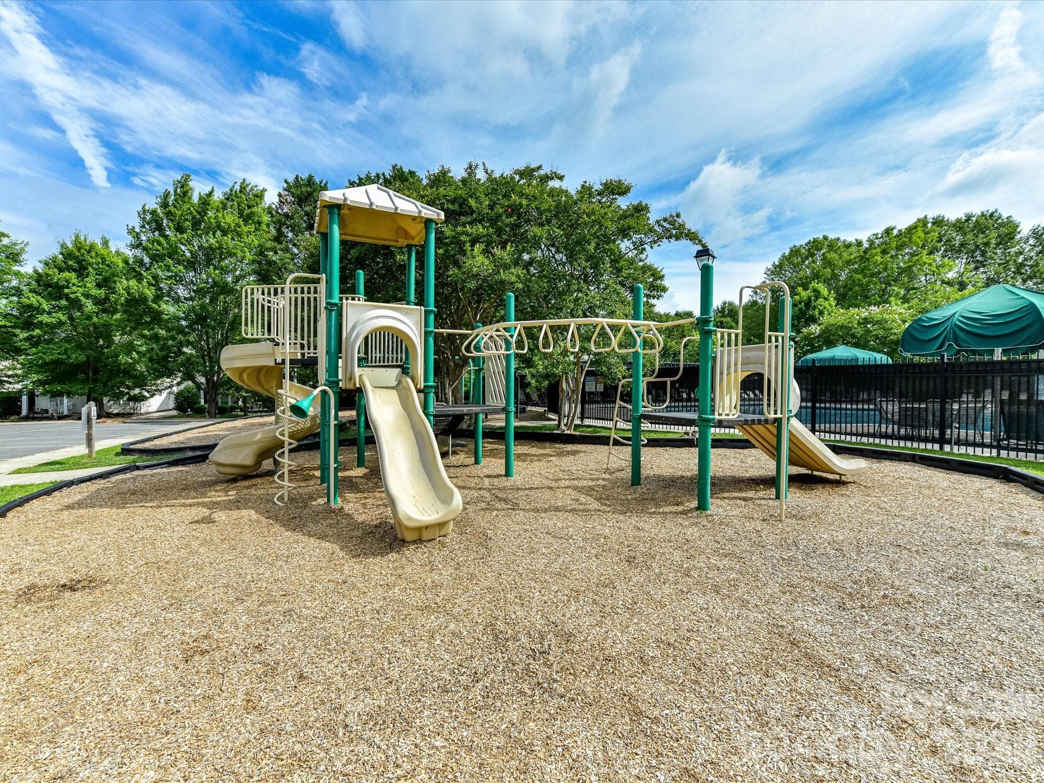 The community playground offers a fun outdoor space with play structures and open areas for recreation, conveniently located near the neighborhood amenities. - Cornelius