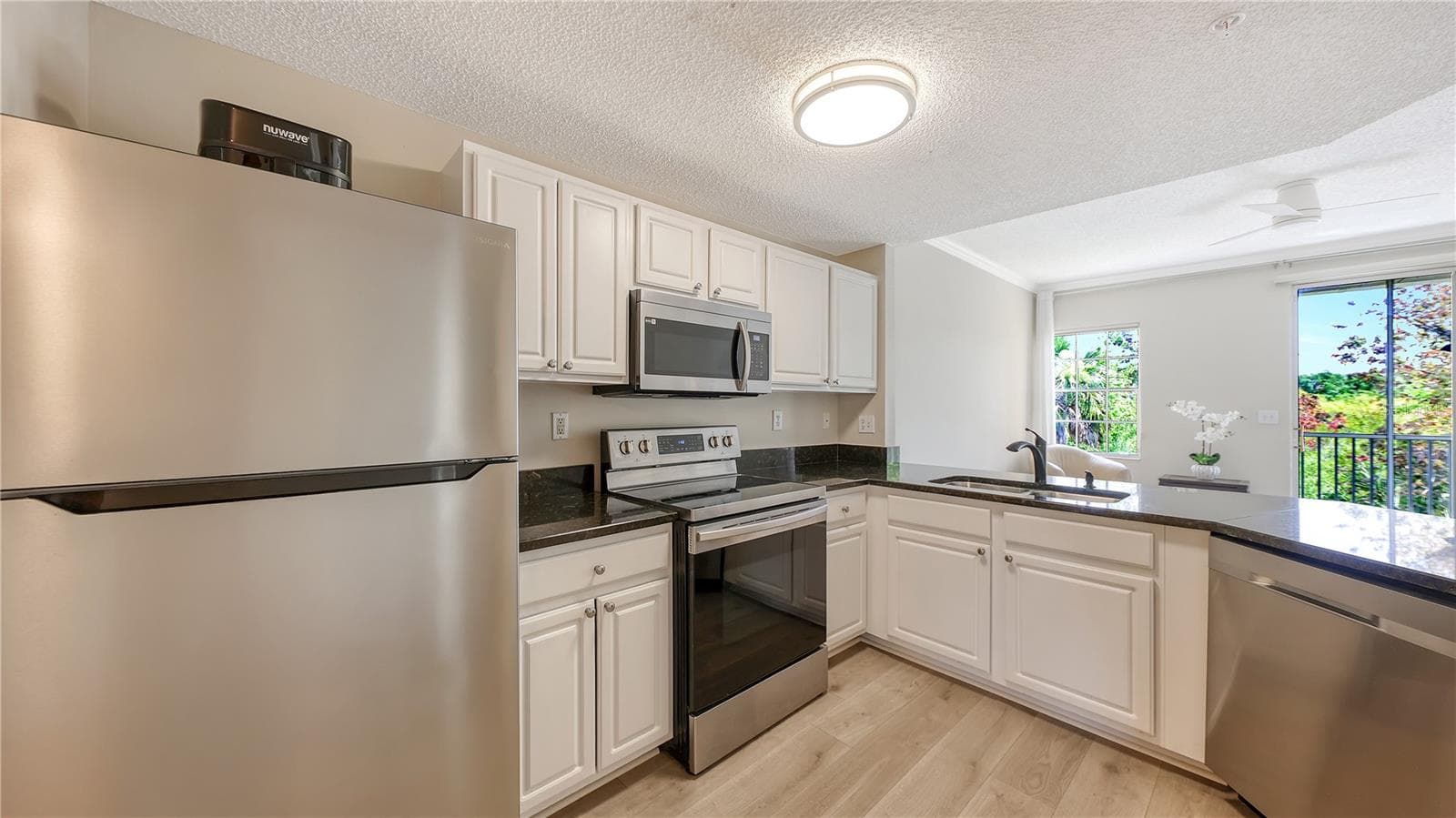 Kitchen. Quartz countertop - 5551 BENTGRASS DR #11-117, SARASOTA